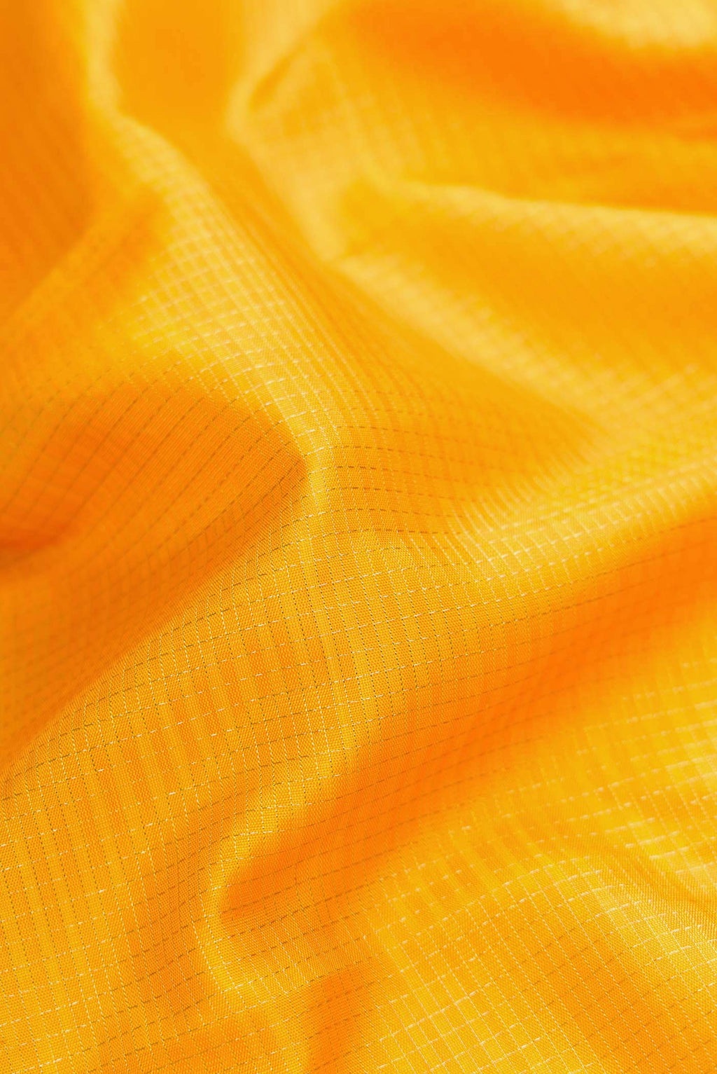 Close up of Pure Silk Pure Zari Mustard Dual Tone Kanjivaram Saree with Checked design on the body and Fancy Border.  displaying folds