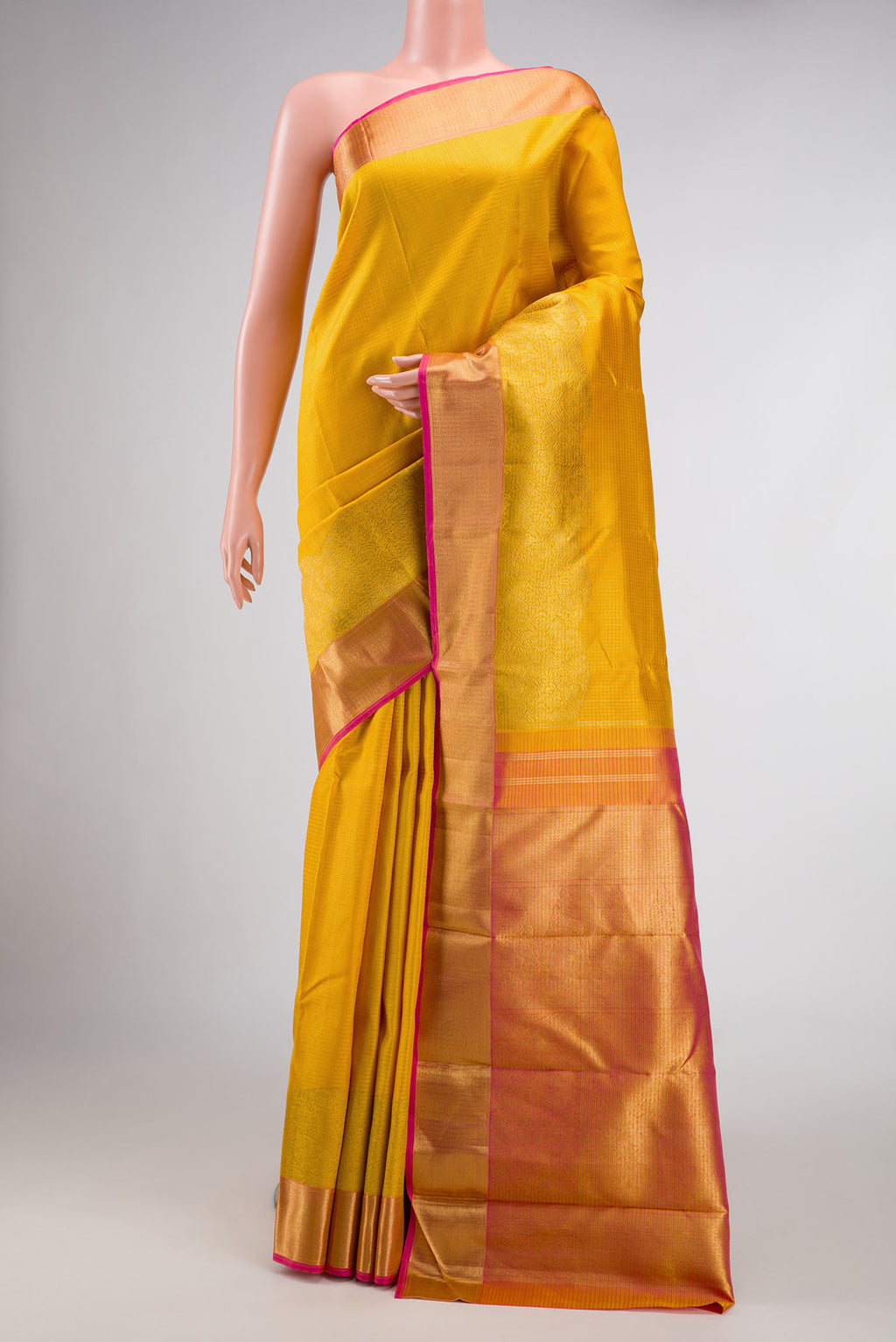 Pure Silk Pure Zari Mustard Dual Tone Kanjivaram Saree with Checked design on the body and Fancy Border.  displayed on a mannequin