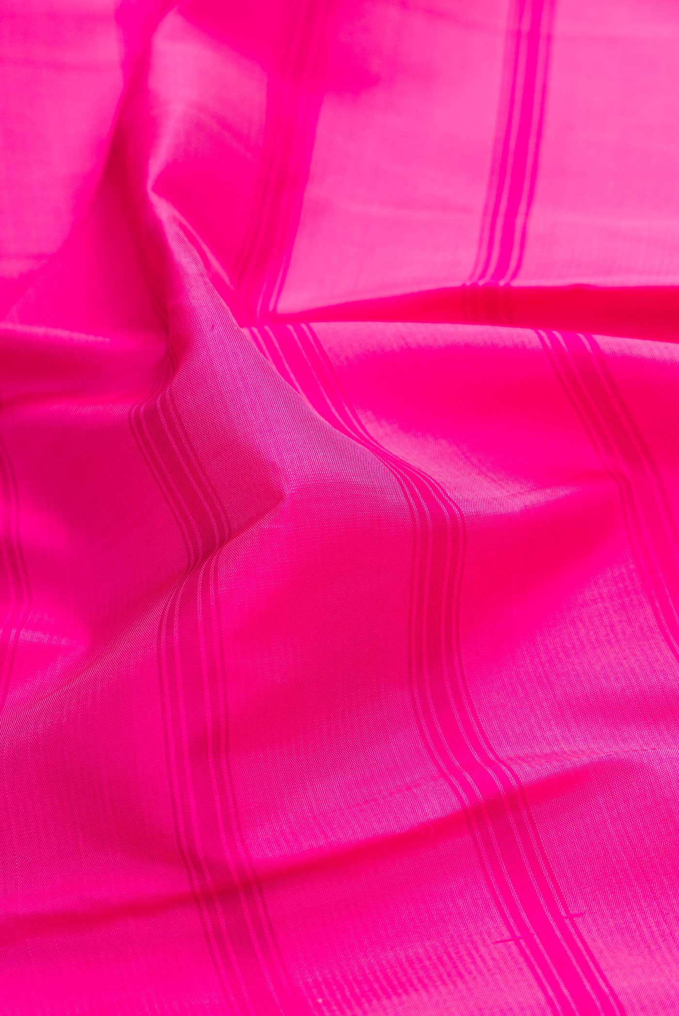 Close up of Pink Dual Tone Kanchipuram Saree with Stripes on the body and Zari Border displaying folds