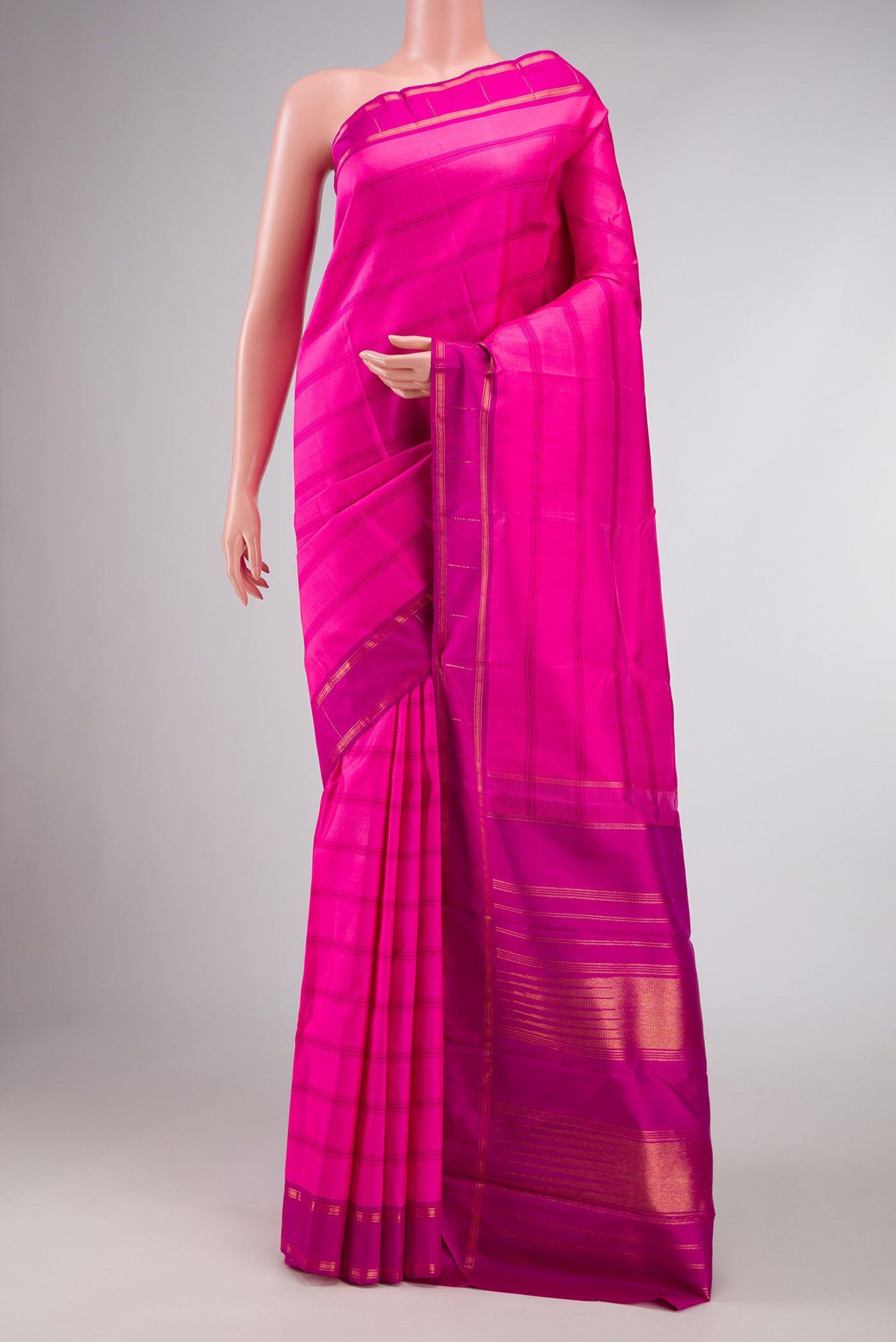 Pink Dual Tone Kanchipuram Saree with Stripes on the body and Zari Border displayed on a mannequin