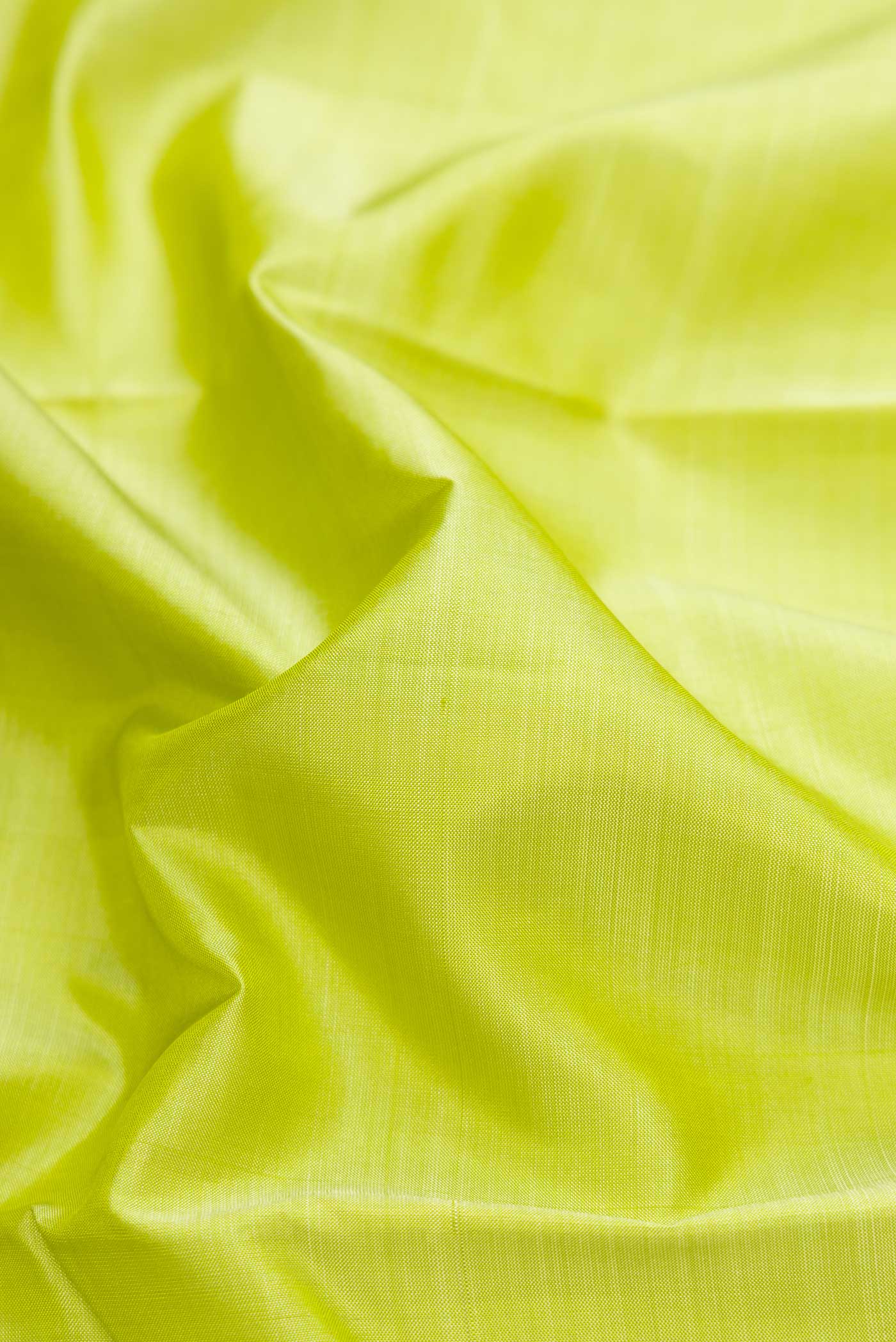 Close up of Pista Green Dual Tone Kanjivaram Silk Saree with Plain Body and Zari Border.  displaying folds