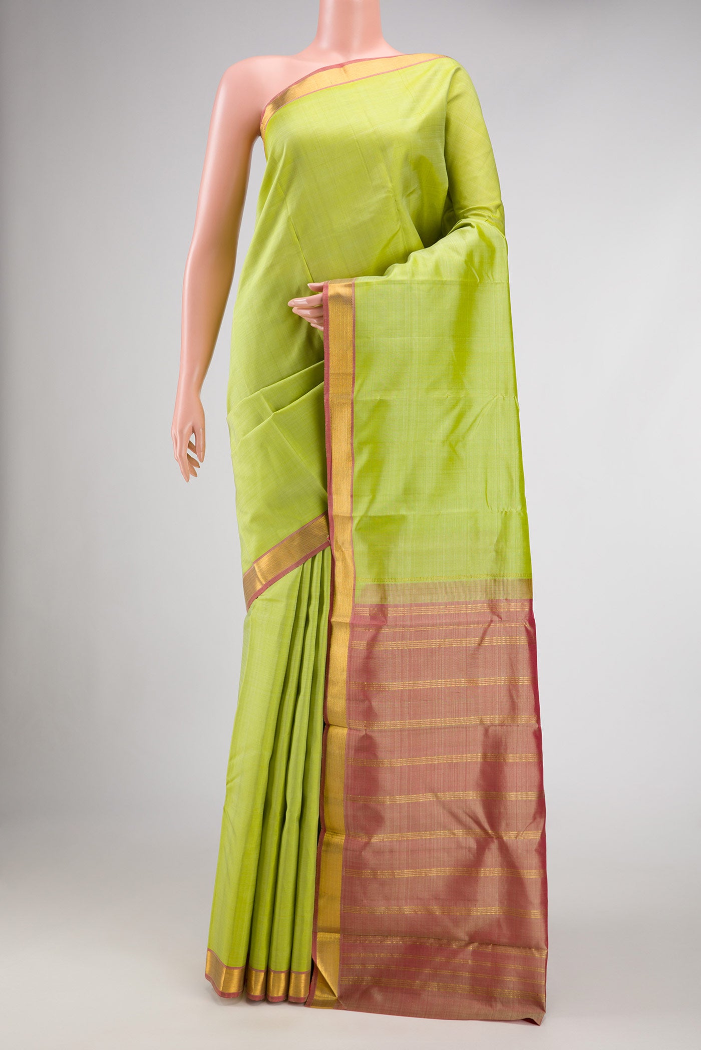 Pista Green Dual Tone Kanjivaram Silk Saree with Plain Body and Zari Border.  displayed on a mannequin