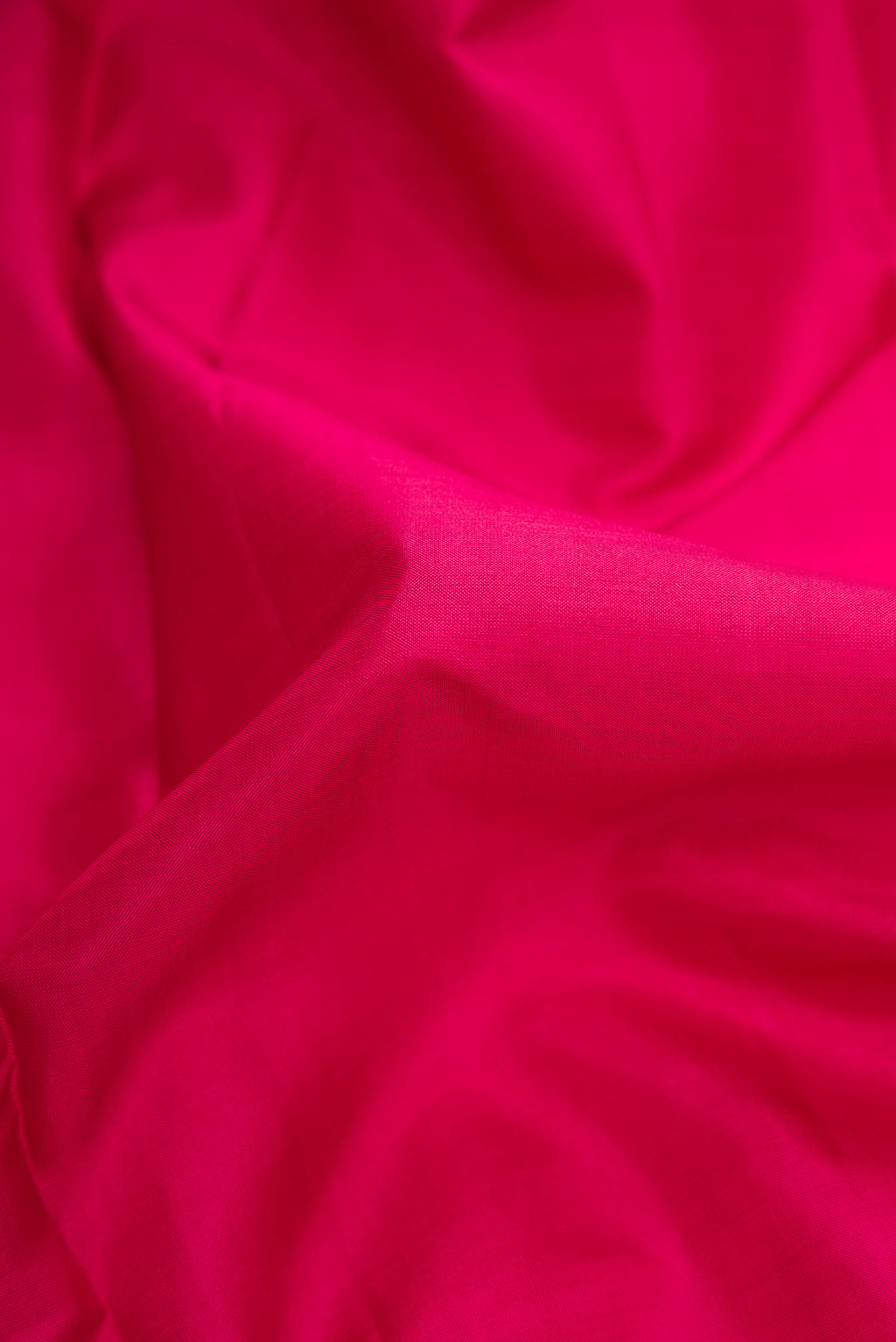 Close up of Pure Silk Pure Zari Maroon Dual Tone Kanjivaram Saree with Plain Body and Zari Border.  displaying folds