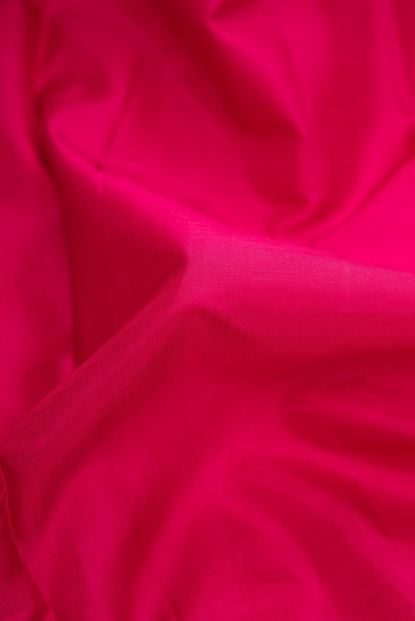 Close up of Pure Silk Pure Zari Maroon Dual Tone Kanjivaram Saree with Plain Body and Zari Border.  displaying folds