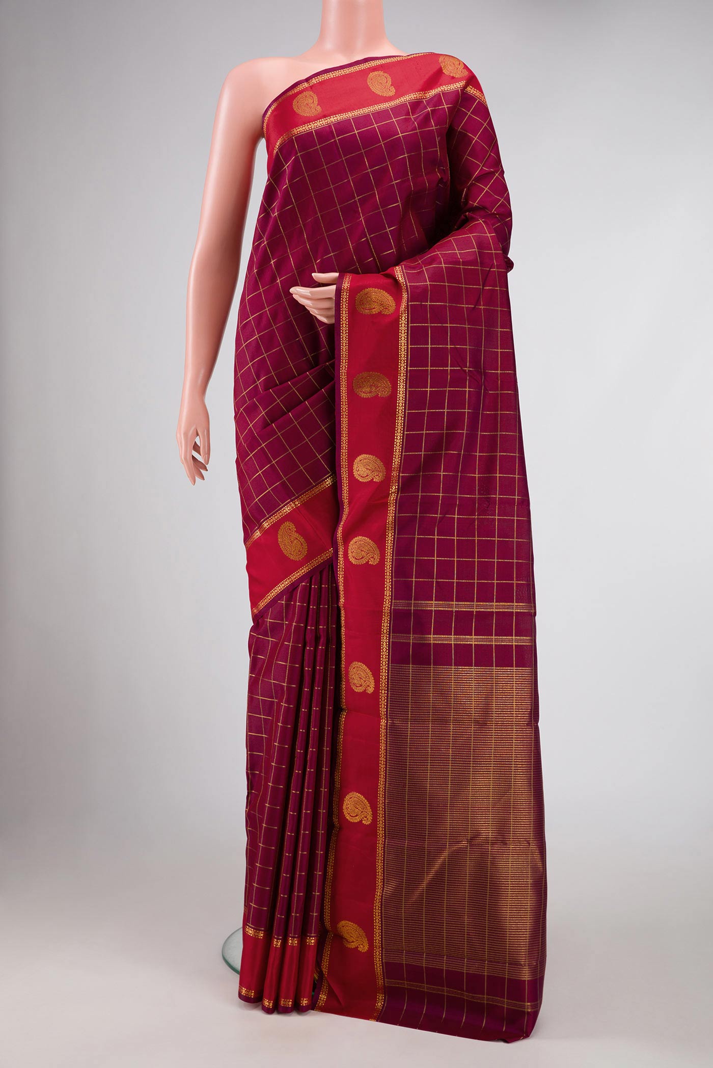 Maroon Dual Tone Kanchipuram Silk Saree with Checked design on the body and Zari Border displayed on a mannequin