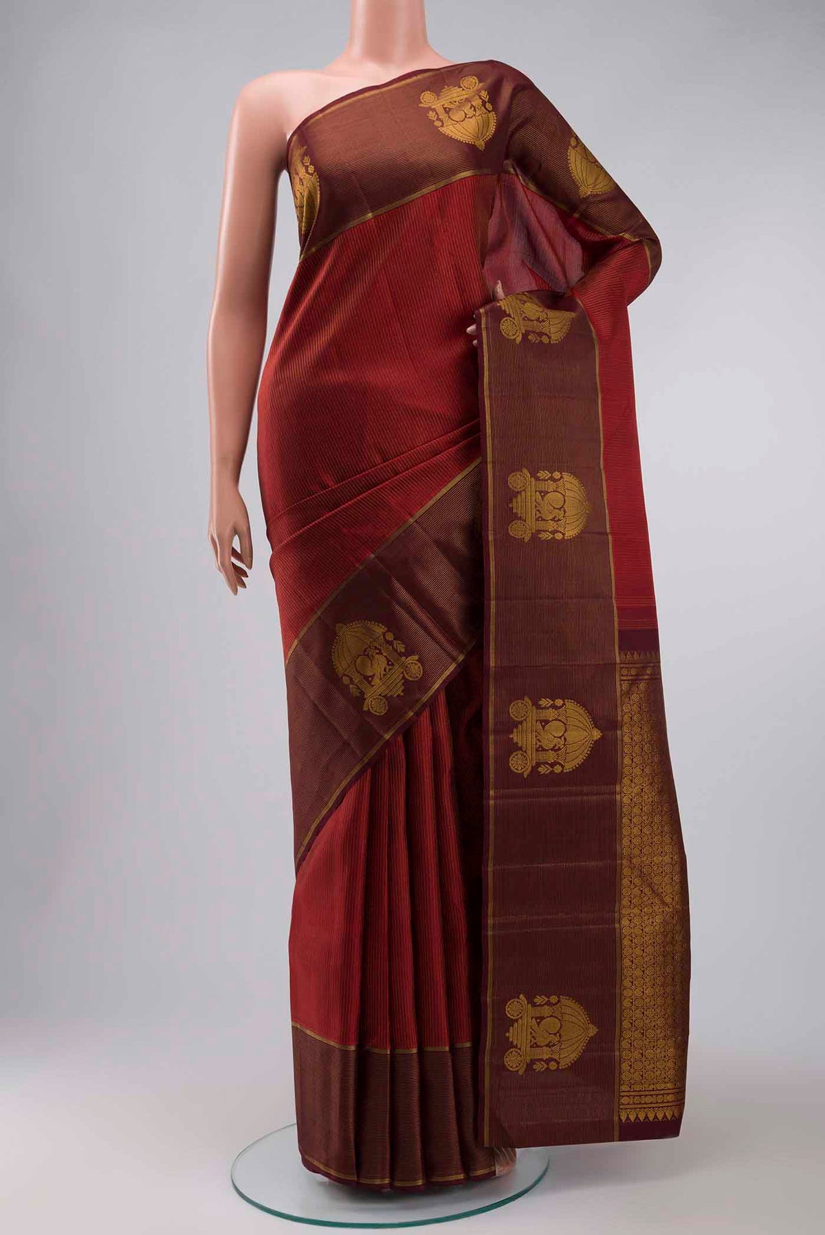 Maroon Kanchipuram Silk Saree with Stripes on the body and Zari Border displayed on a mannequin
