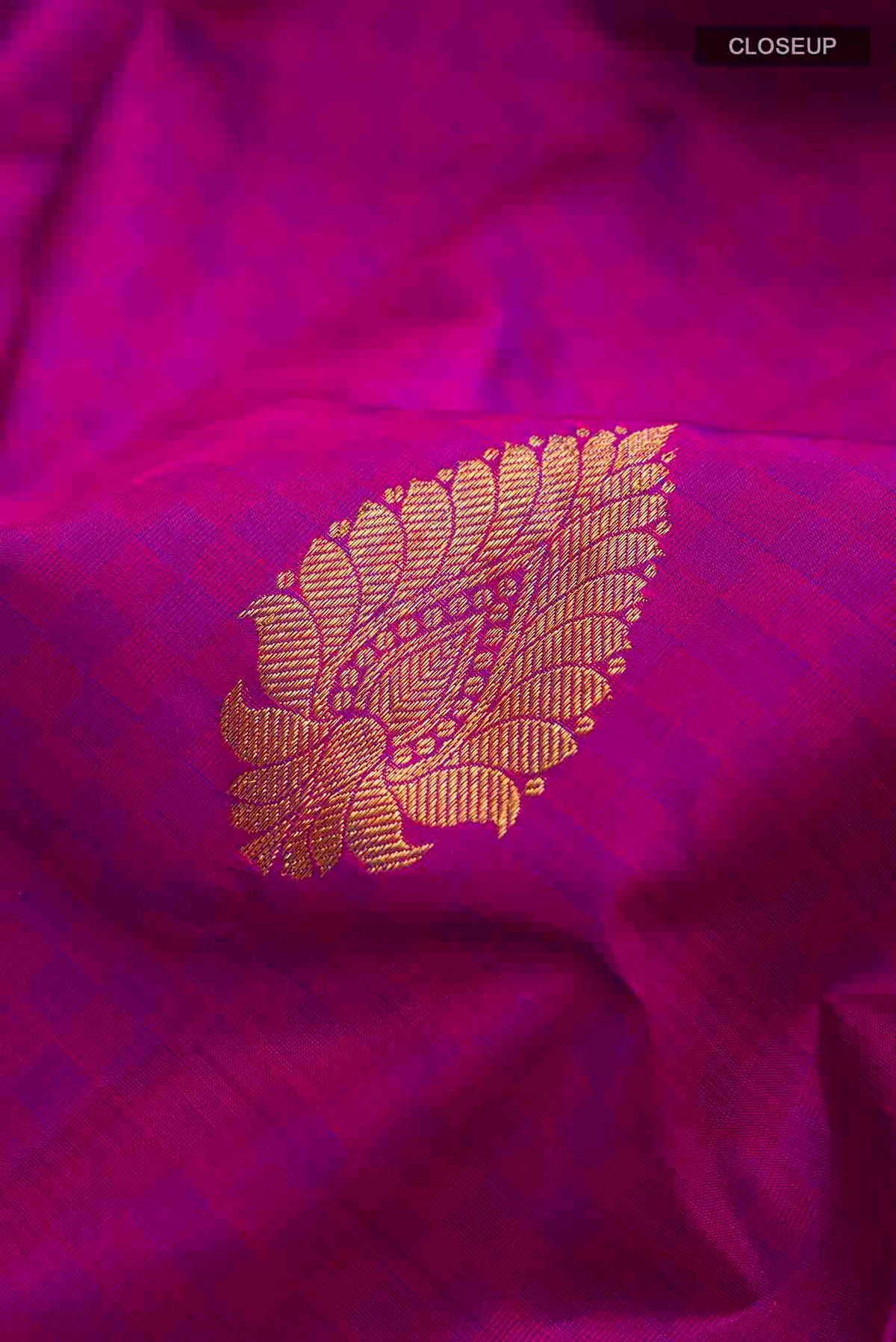 Close up of Purple Kanchipuram Silk Saree with Zari Butta on the body and Zari Border displaying folds
