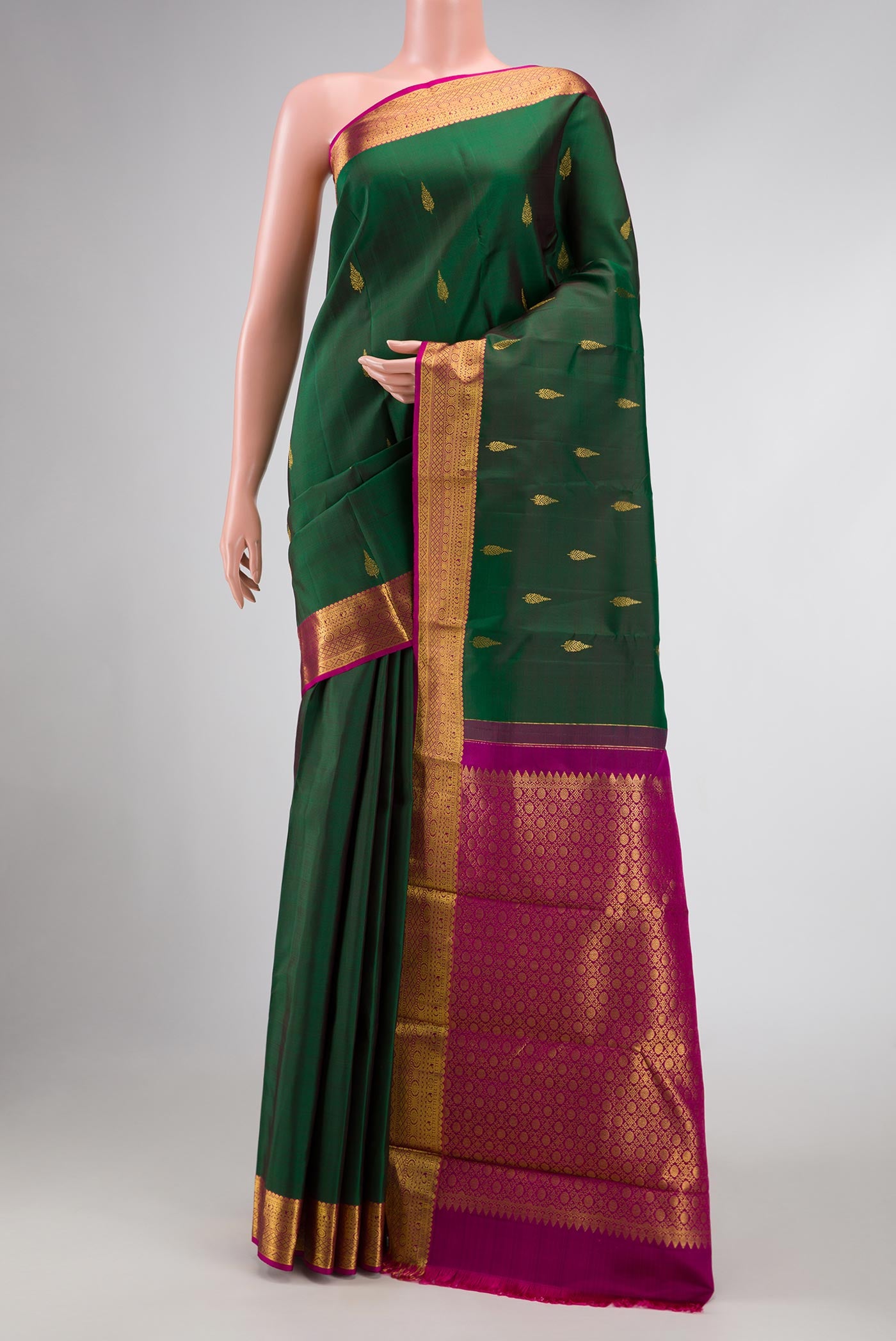 Green Dual Tone Kanchipuram Silk Saree with Zari Butta on the body and Zari Border displayed on a mannequin
