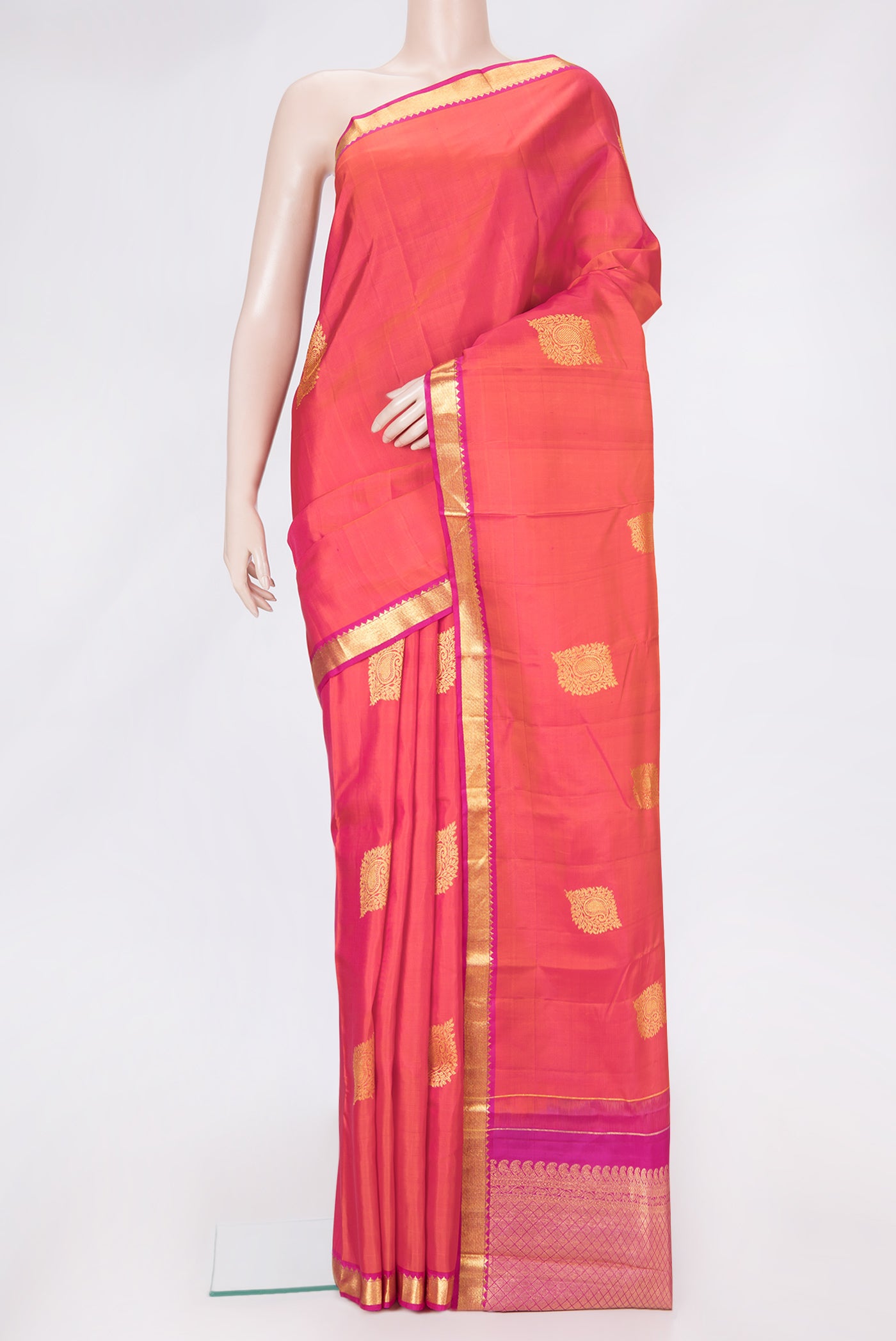 Coral Dual Tone Kanchipuram Silk Saree with Zari Butta on the body and Zari Border.  displayed on a mannequin