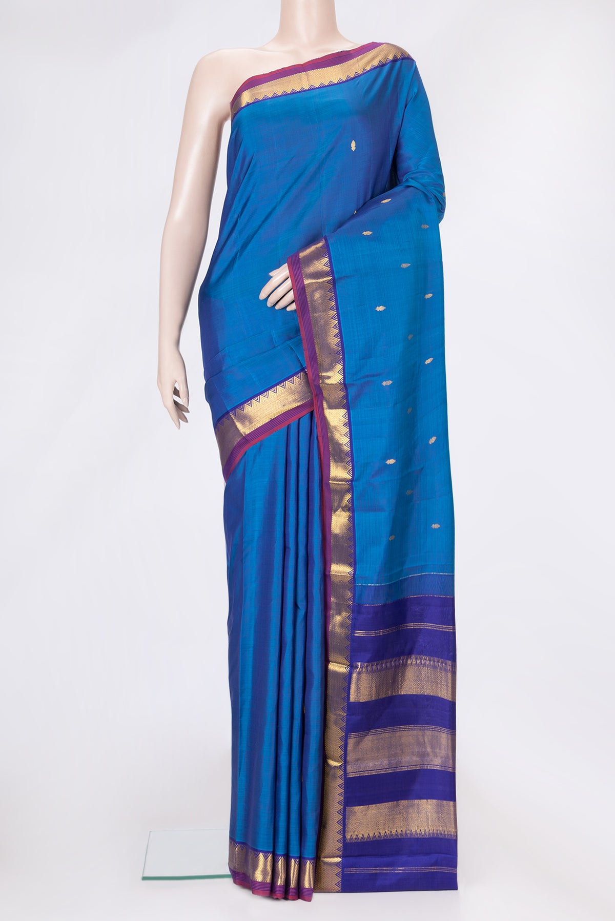 Peacock Blue Dual Tone Kanchipuram Silk Saree with Zari Butta on the body and Zari Border.  displayed on a mannequin