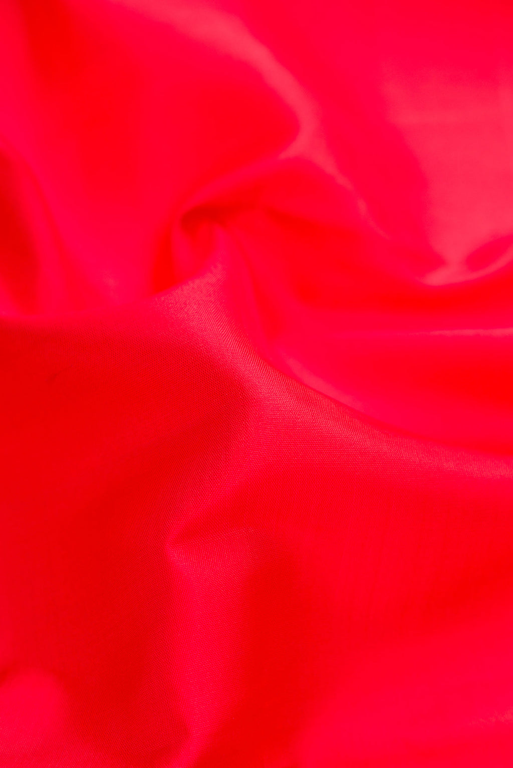 Close up of Red Dual Tone Kanjivaram Silk Saree with Plain Body and Zari Border.  displaying folds