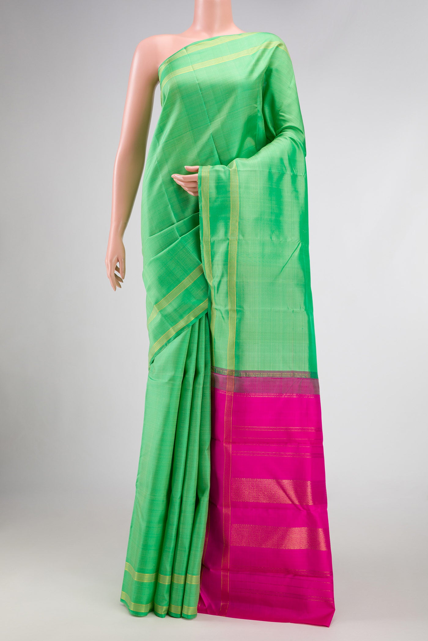 Pista Green Dual Tone Kanjivaram Silk Saree with Plain Body and Zari Border.  displayed on a mannequin