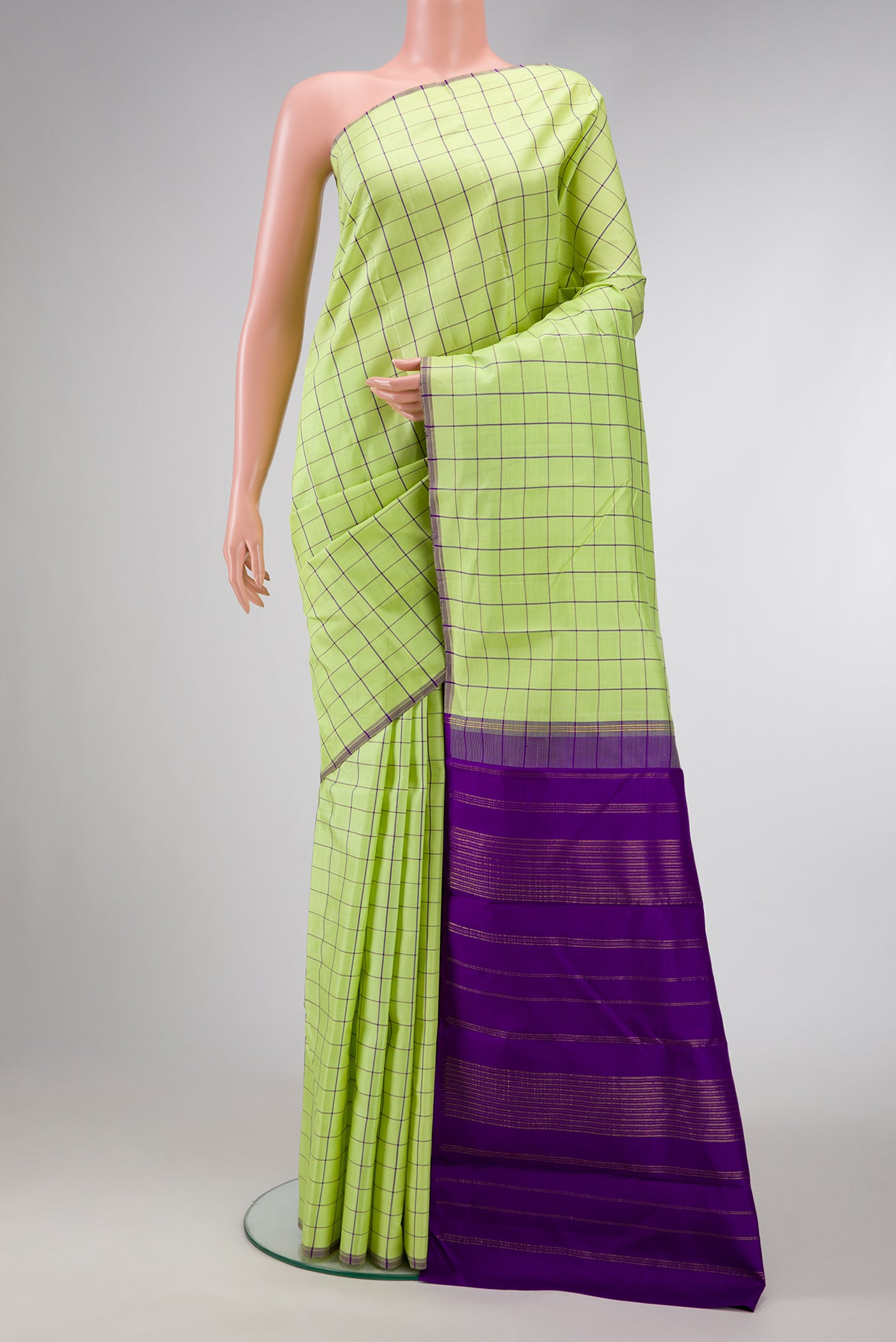 Pista Green Dual Tone Kanjivaram Silk Saree with Checked design on the body and Without Border.  displayed on a mannequin