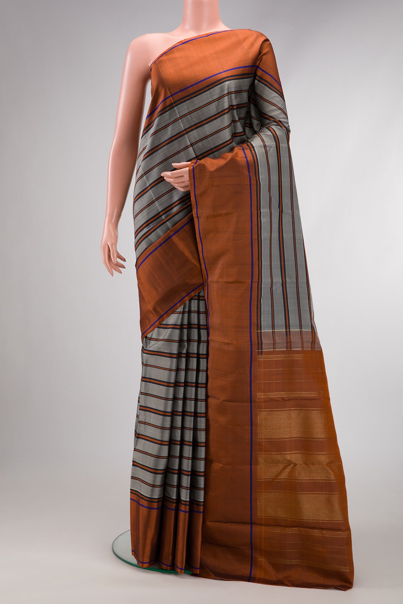 Grey Dual Tone Kanjivaram Silk Saree with Stripes on the body and Plain Border.  displayed on a mannequin