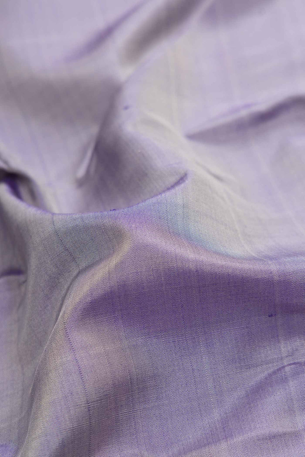 Close up of Lavender Dual Tone Kanchipuram Silk Saree with Plain Body and Zari Border.  displaying folds