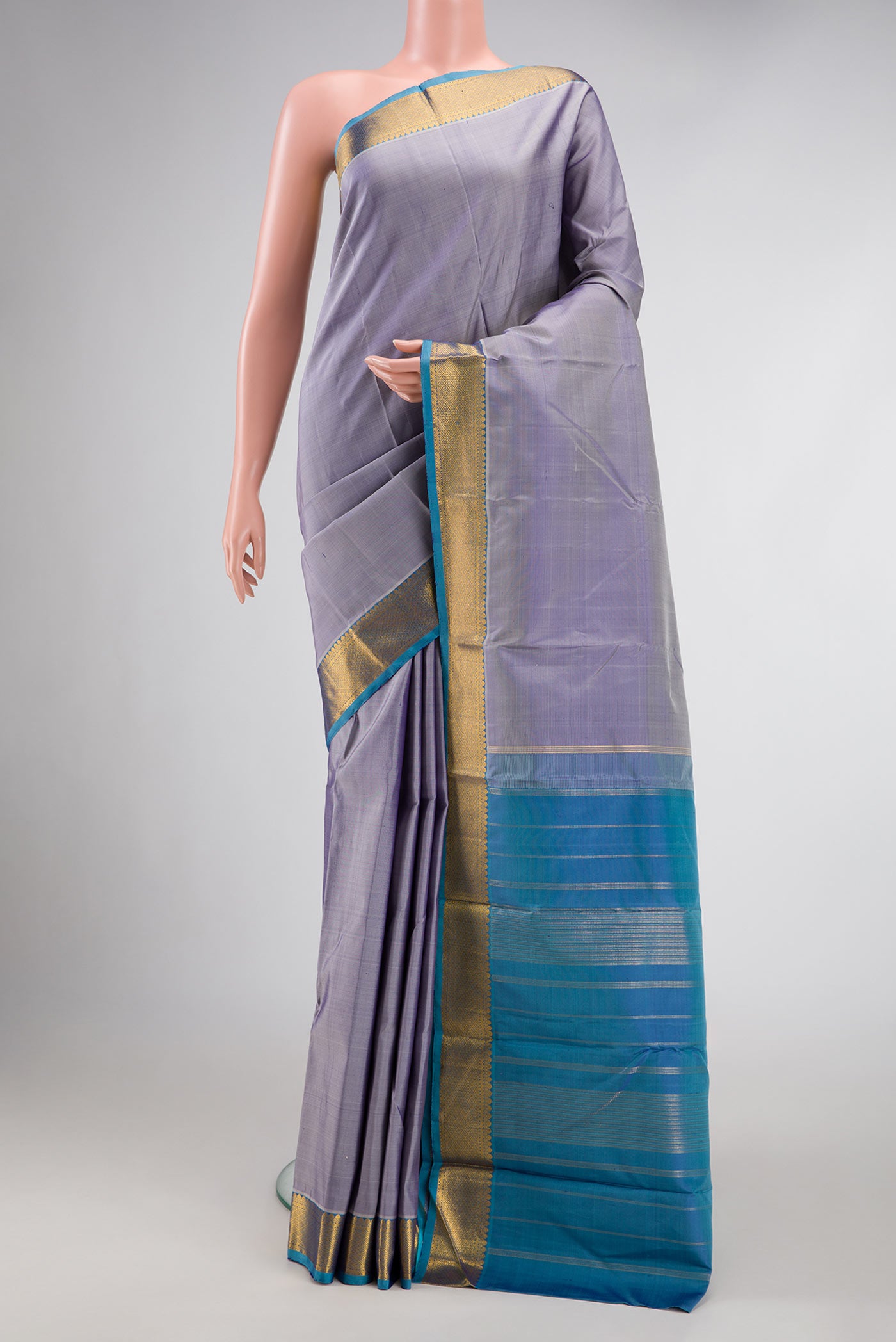 Lavender Dual Tone Kanchipuram Silk Saree with Plain Body and Zari Border.  displayed on a mannequin
