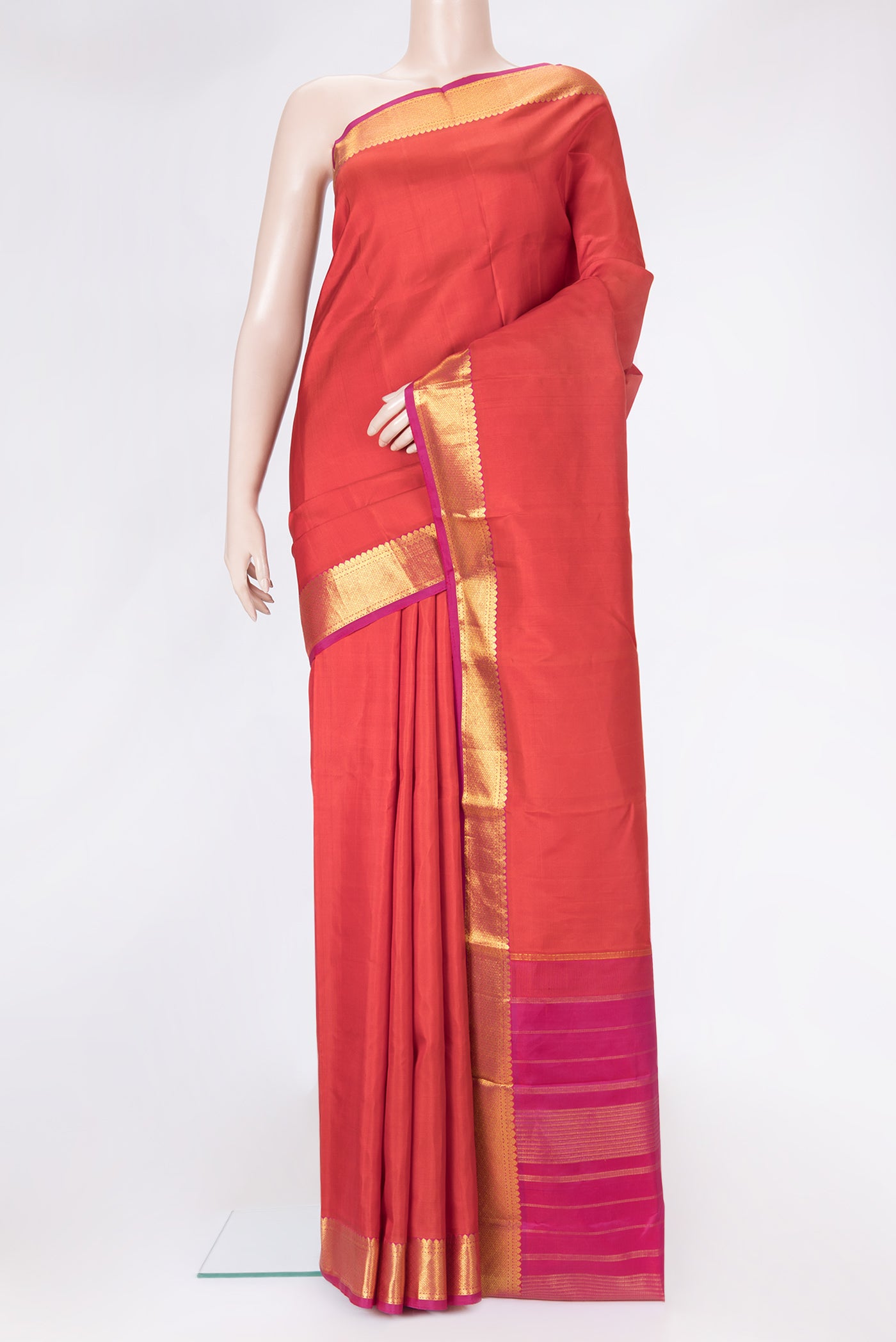Orange Dual Tone Kanchipuram Silk Saree with Plain Body and Zari Border.  displayed on a mannequin