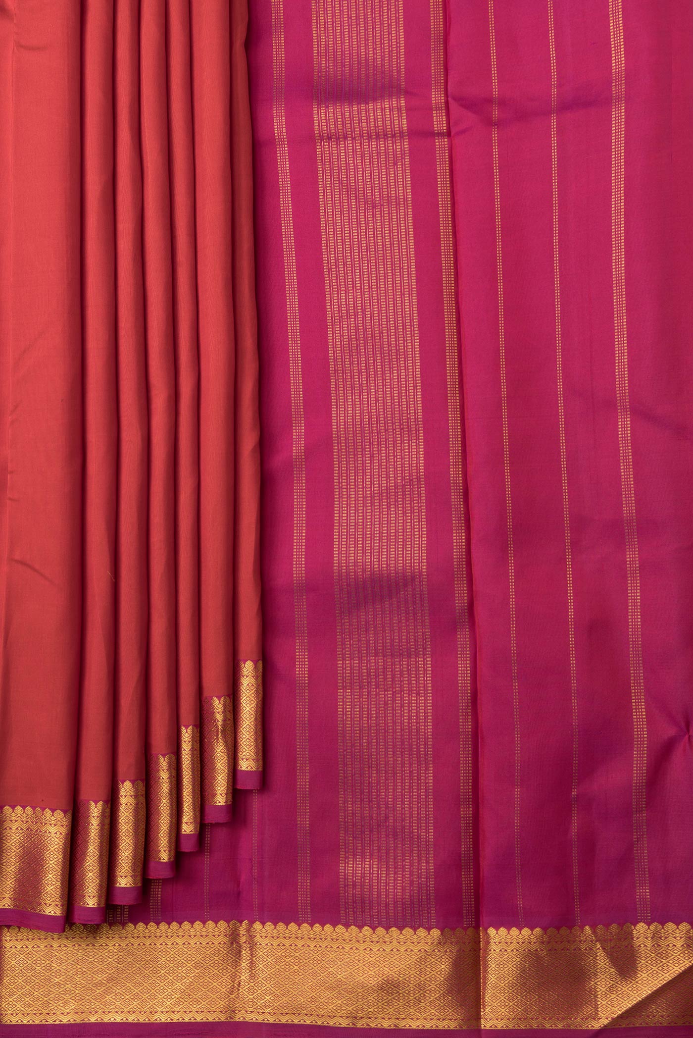 Pleats and pallu of Orange Dual Tone Kanchipuram Silk Saree with Plain Body and Zari Border. 