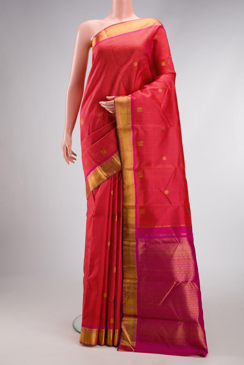 Coral Dual Tone Kanchipuram Silk Saree with Checked design on the body and Zari Border.  displayed on a mannequin
