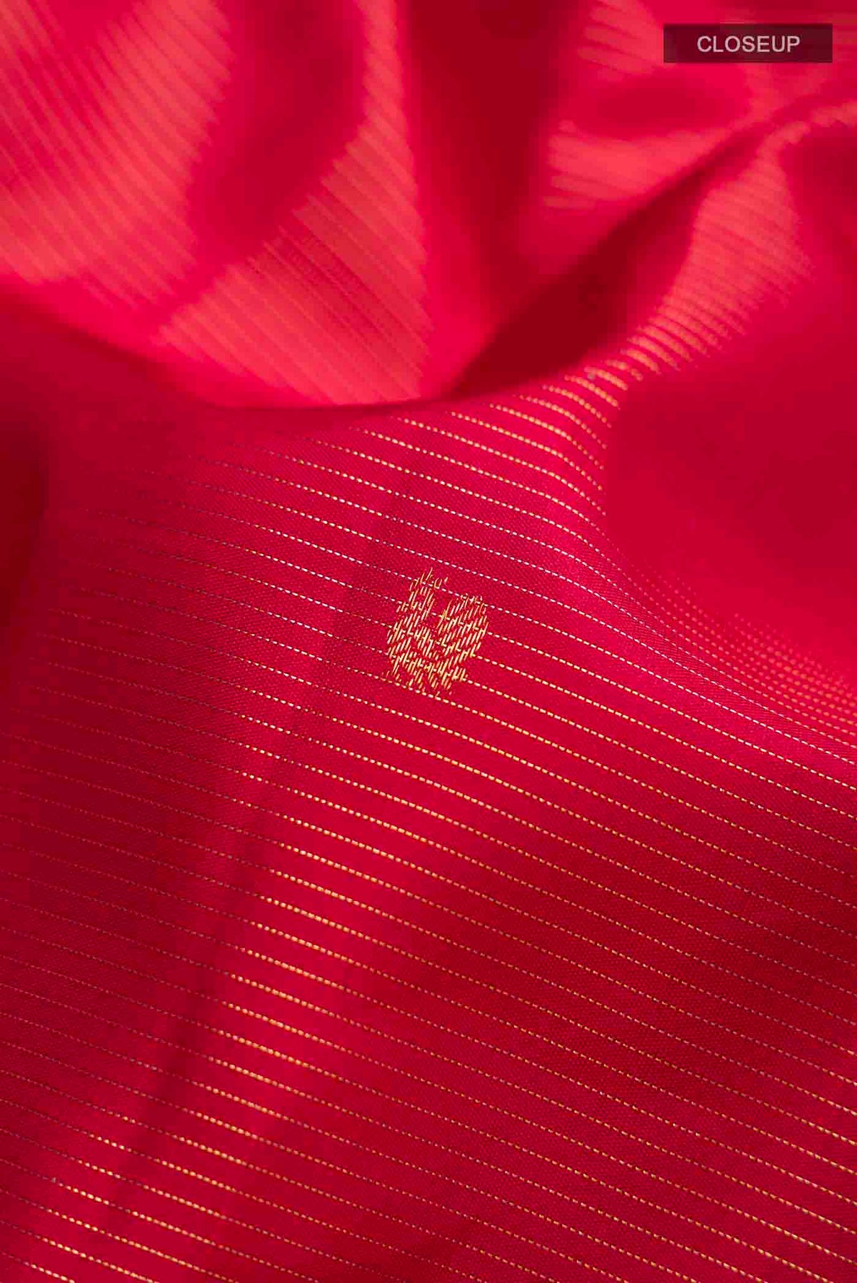 Close up of Maroon Kanchipuram Silk Saree with Stripes on the body and Zari Border displaying folds