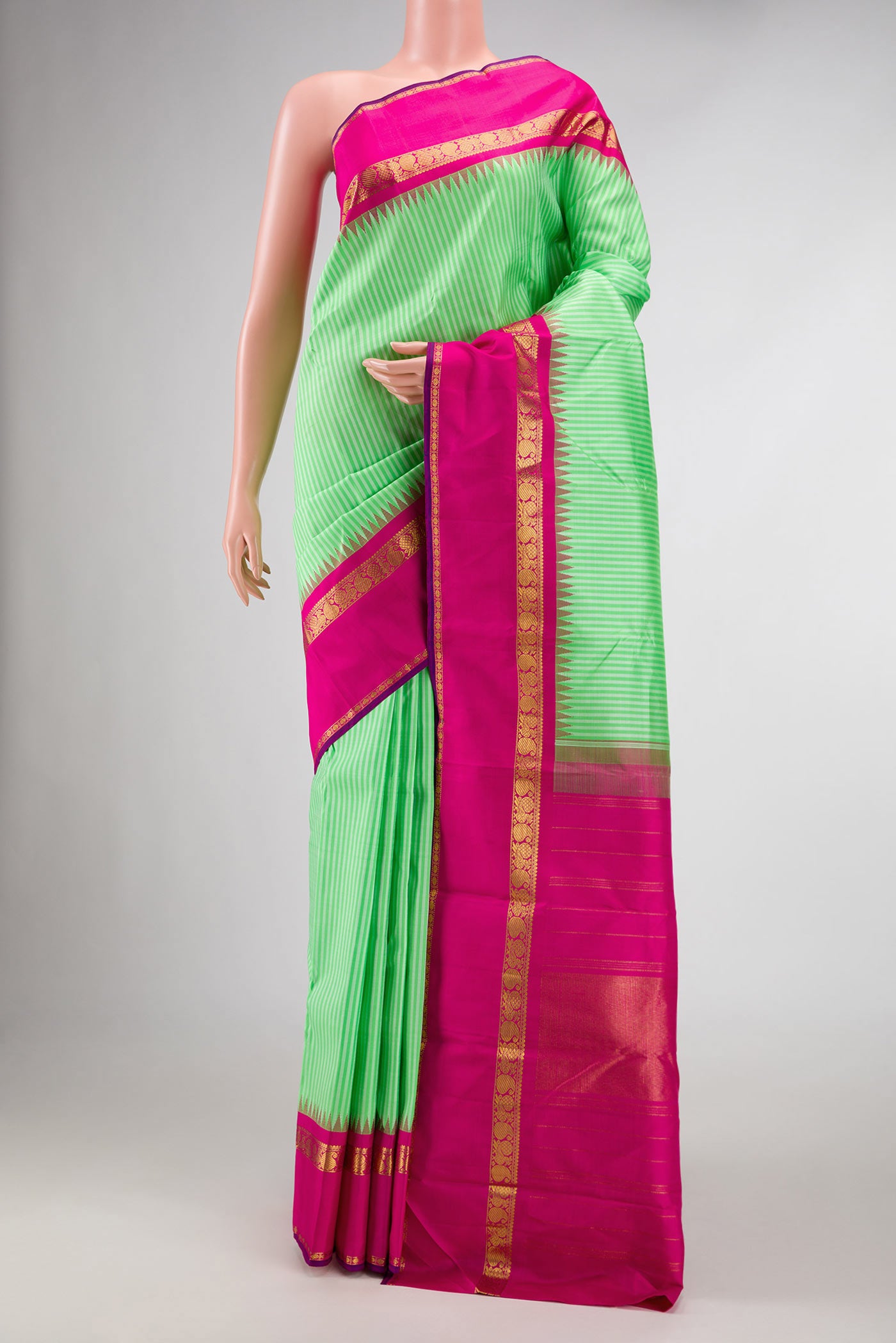 Pure Silk Pure Zari Parrot Green Dual Tone Kanchipuram Saree with Stripes on the body and Zari Border displayed on a mannequin