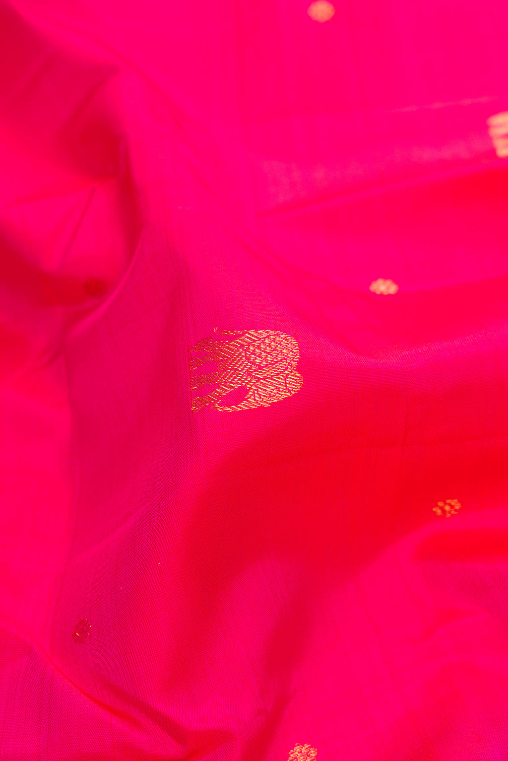 Close up of Pink Dual Tone Kanchipuram Silk Saree with Zari Butta on the body and Zari Border.  displaying folds