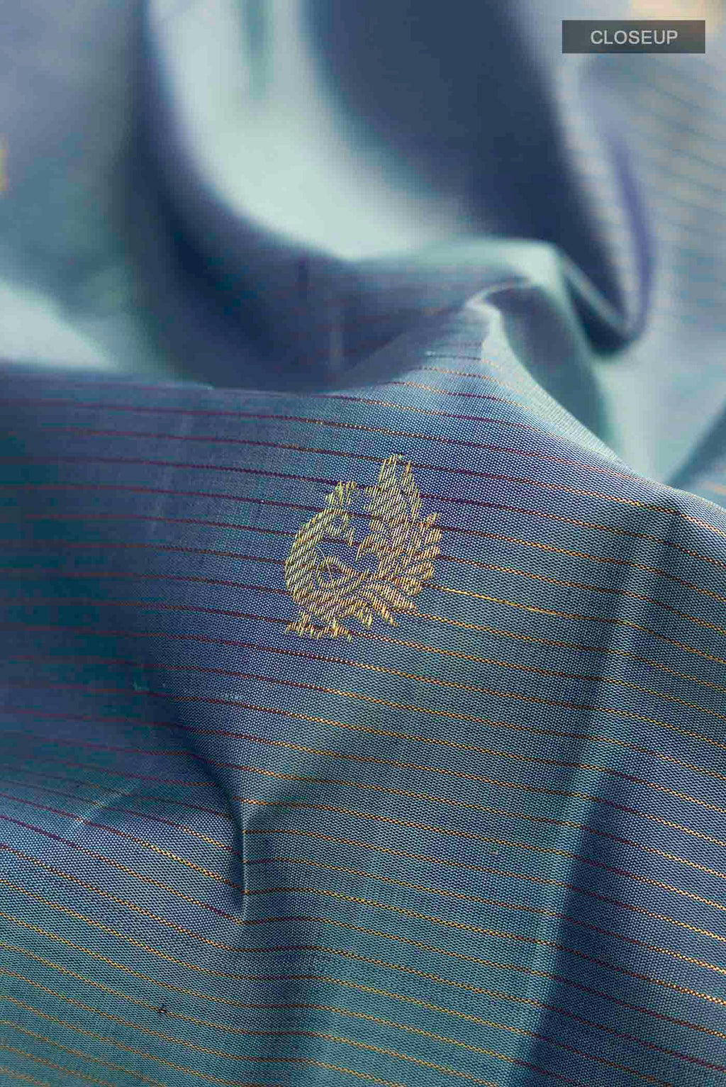 Close up of Blue Kanchipuram Silk Saree with Zari Butta on the body and Zari Border displaying folds