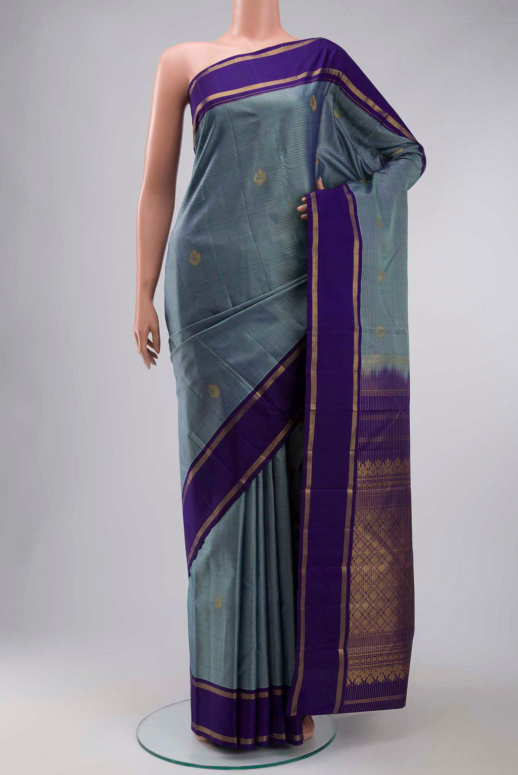 Blue Kanchipuram Silk Saree with Zari Butta on the body and Zari Border displayed on a mannequin