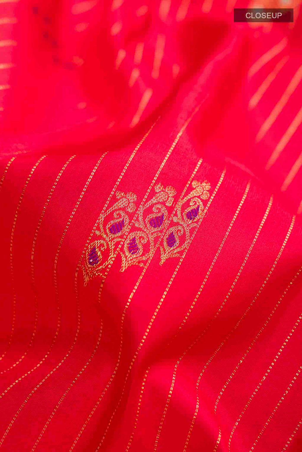 Close up of Red Kanchipuram Silk Saree with Stripes on the body and Zari Border displaying folds