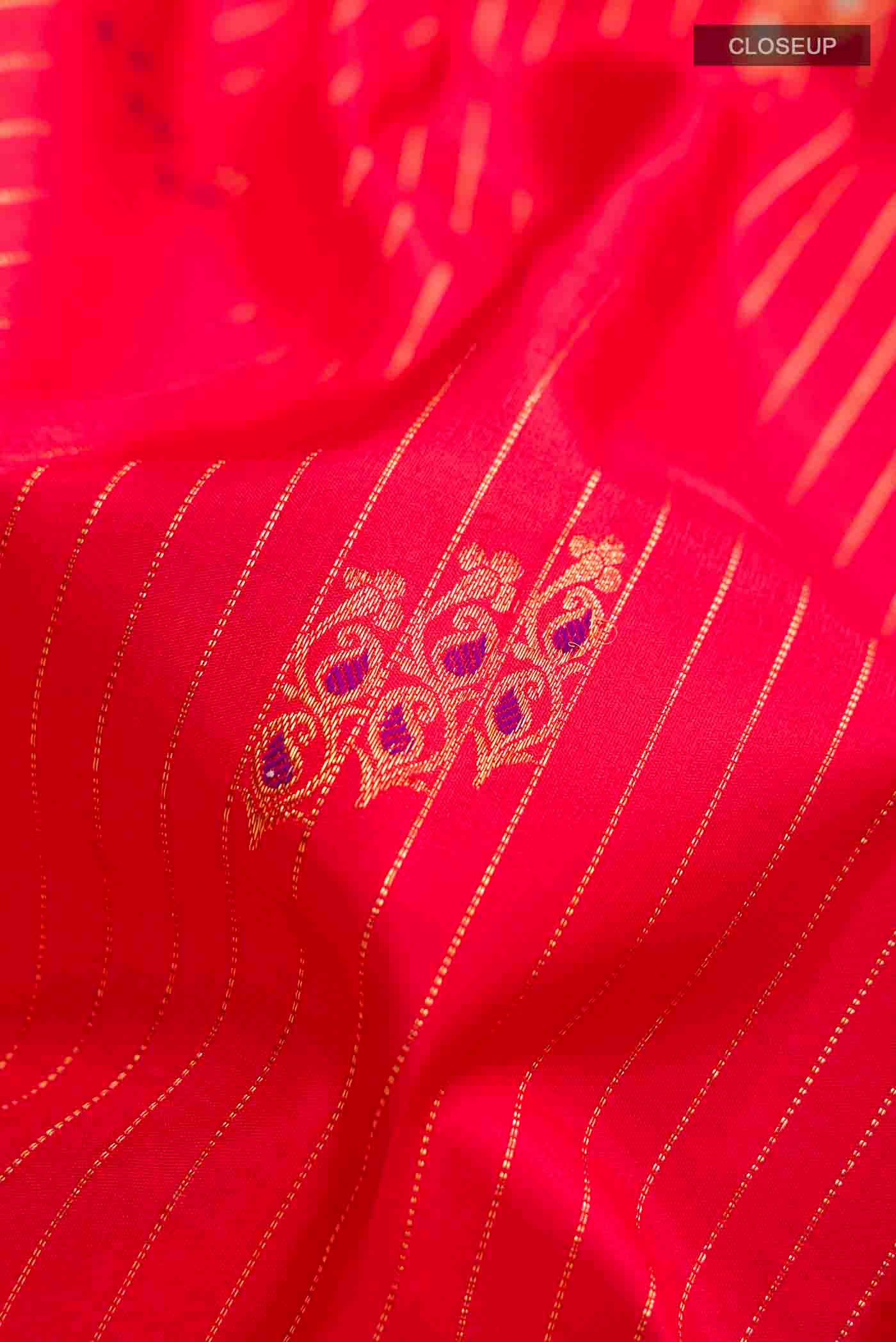 Close up of Red Kanchipuram Silk Saree with Stripes on the body and Zari Border displaying folds
