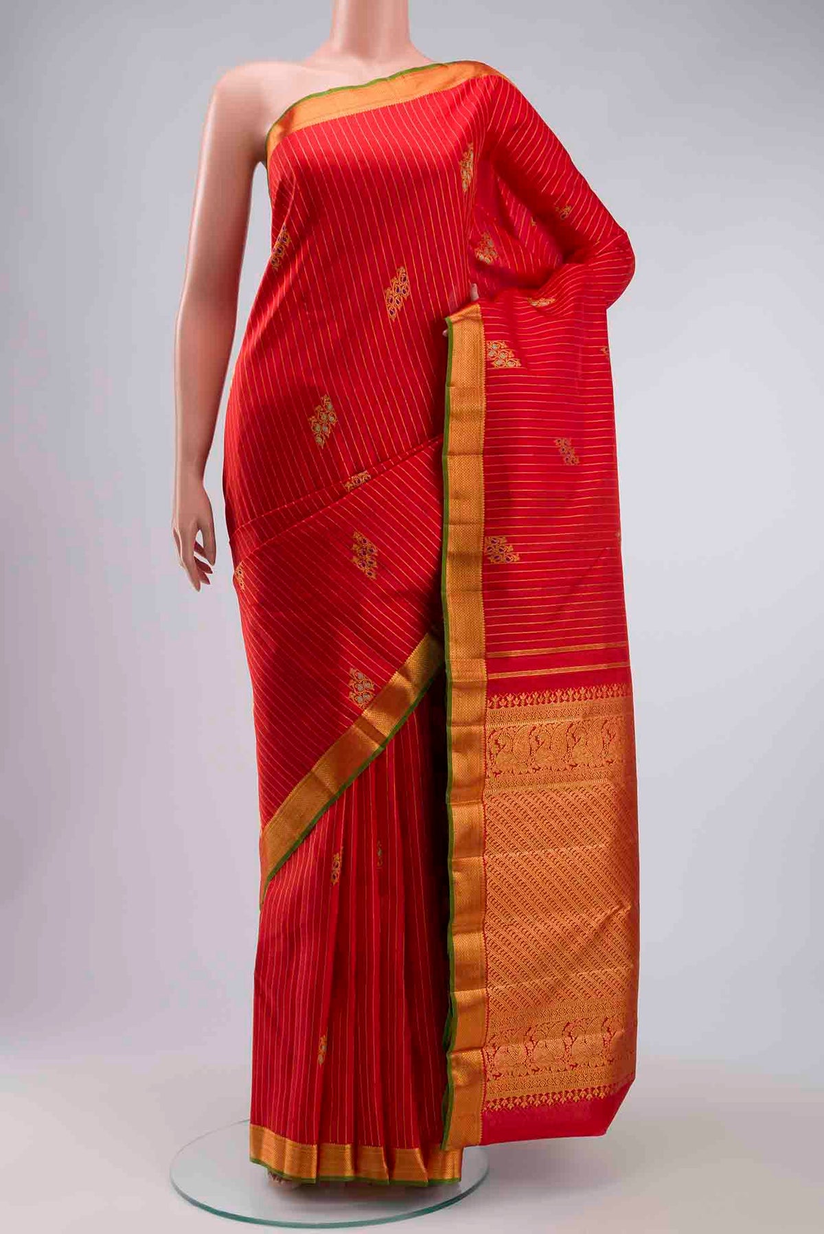 Red Kanchipuram Silk Saree with Stripes on the body and Zari Border displayed on a mannequin