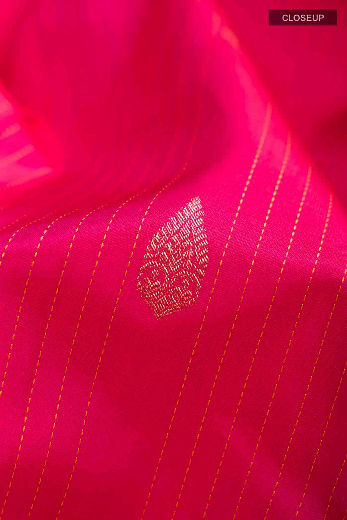 Close up of Pink Kanchipuram Silk Saree with Zari Butta on the body and Plain Border displaying folds