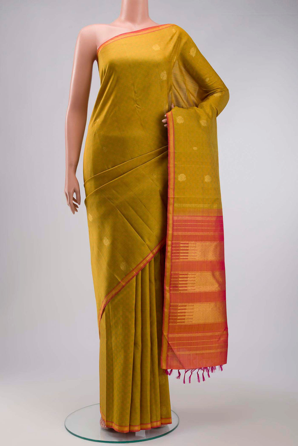 Green Kanchipuram Silk Saree with Zari Butta on the body and Zari Border displayed on a mannequin