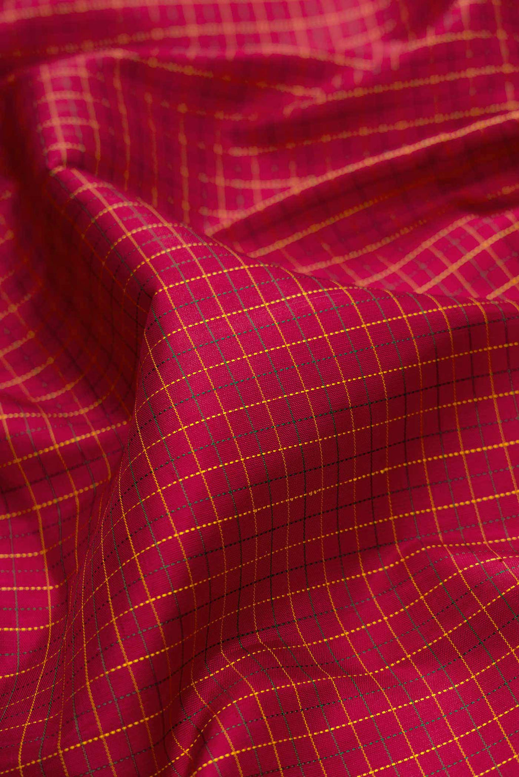 Close up of Maroon Dual Tone Kanchipuram Silk Saree with Checked design on the body and Zari Border.  displaying folds