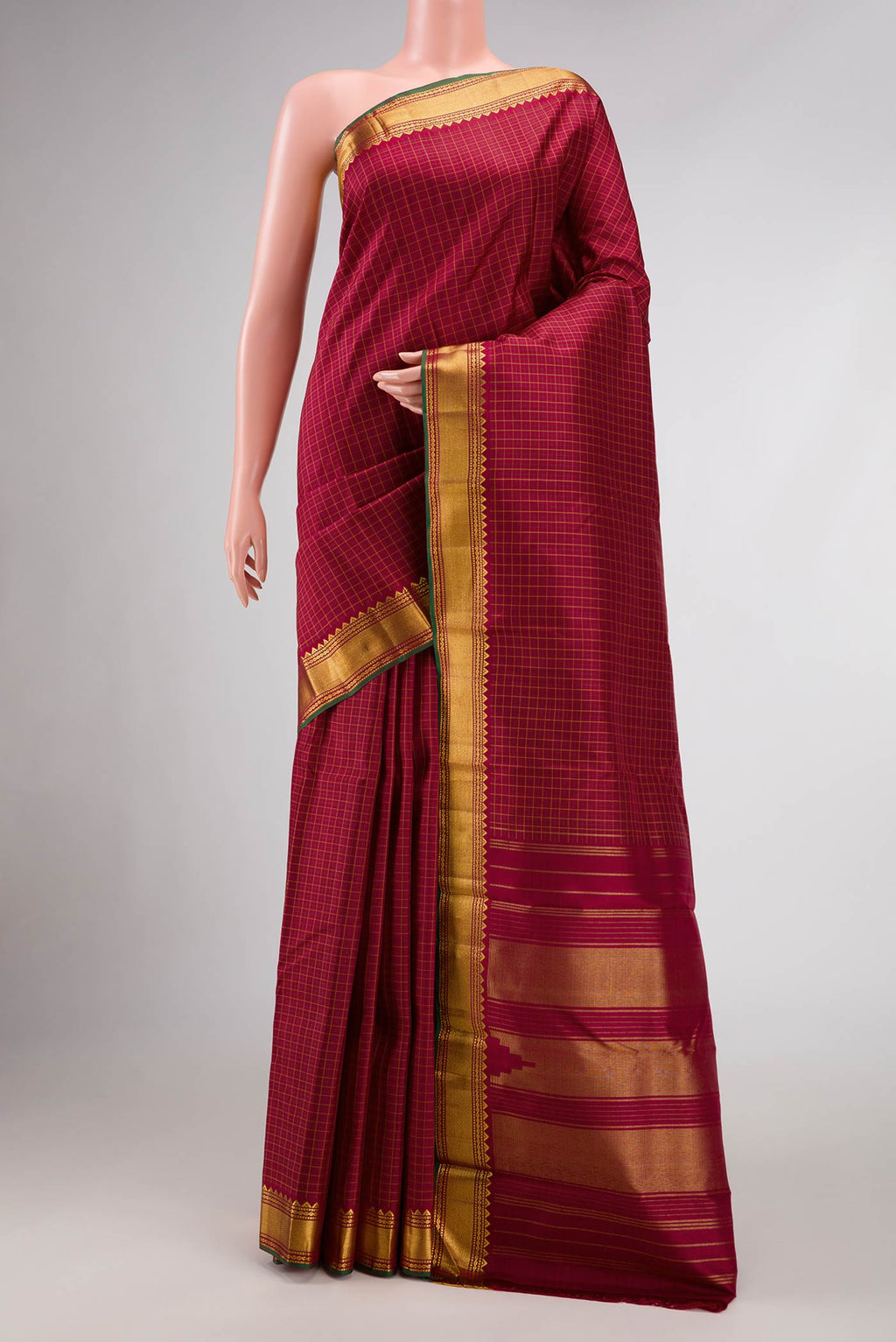 Maroon Dual Tone Kanchipuram Silk Saree with Checked design on the body and Zari Border.  displayed on a mannequin