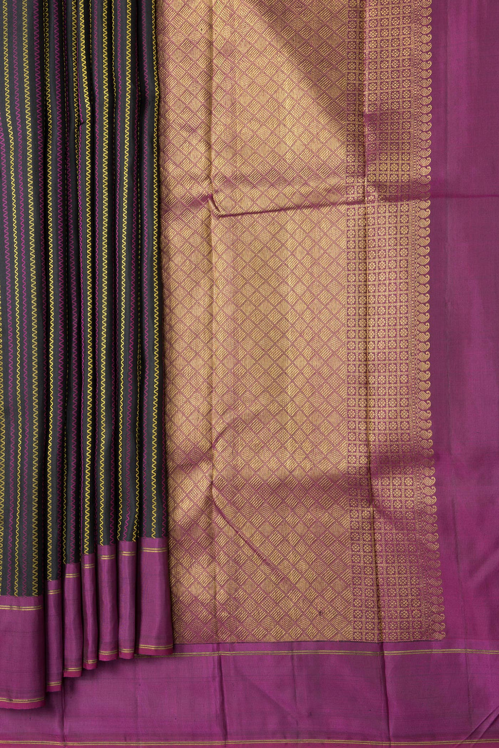 Pleats and pallu of Black Dual Tone Kanchipuram Silk Saree with Stripes on the body and Ganga Jamuna Border. 