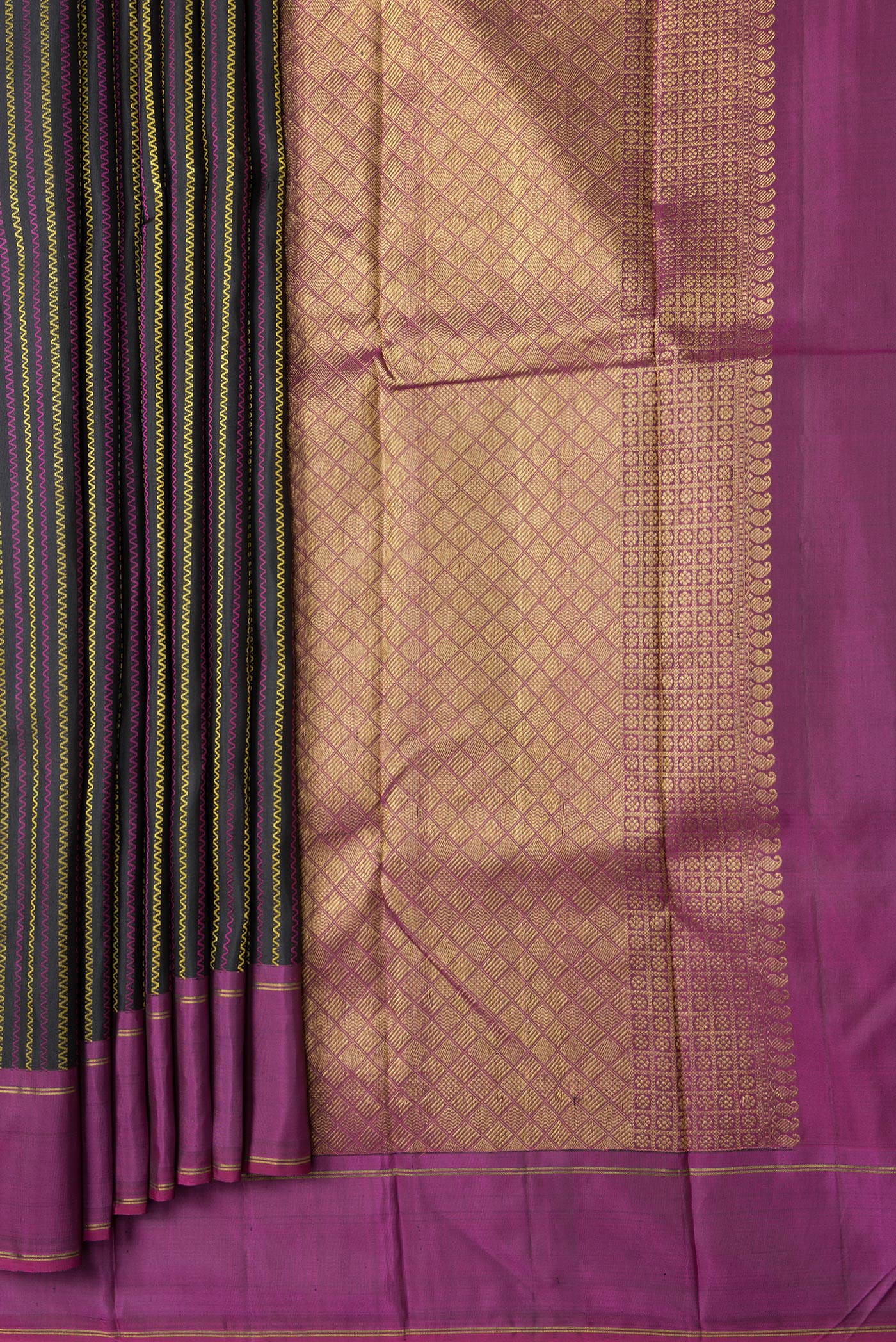 Pleats and pallu of Black Dual Tone Kanchipuram Silk Saree with Stripes on the body and Ganga Jamuna Border. 