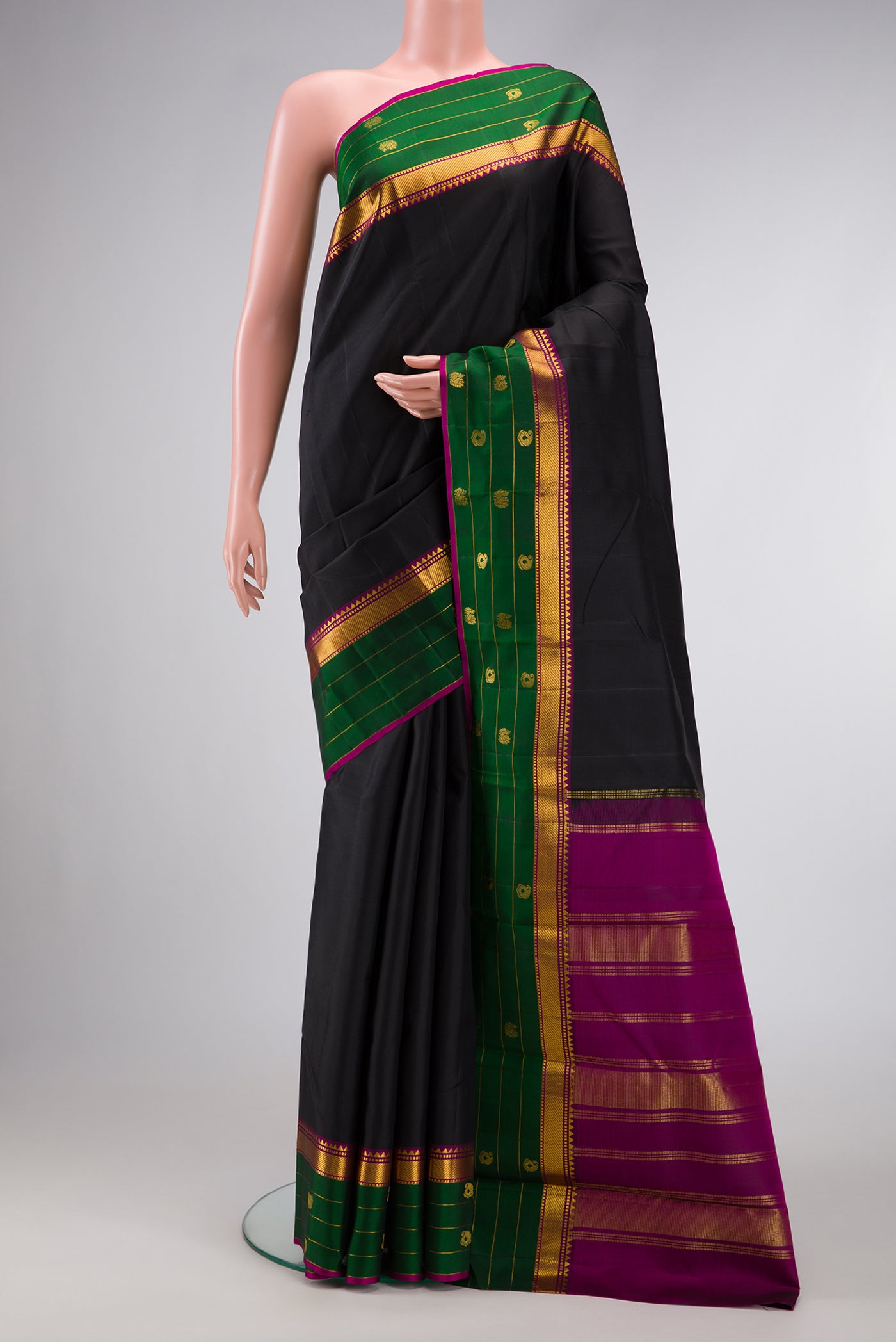 Black Dual Tone Kanchipuram Silk Saree with Plain Body and Fancy Border.  displayed on a mannequin