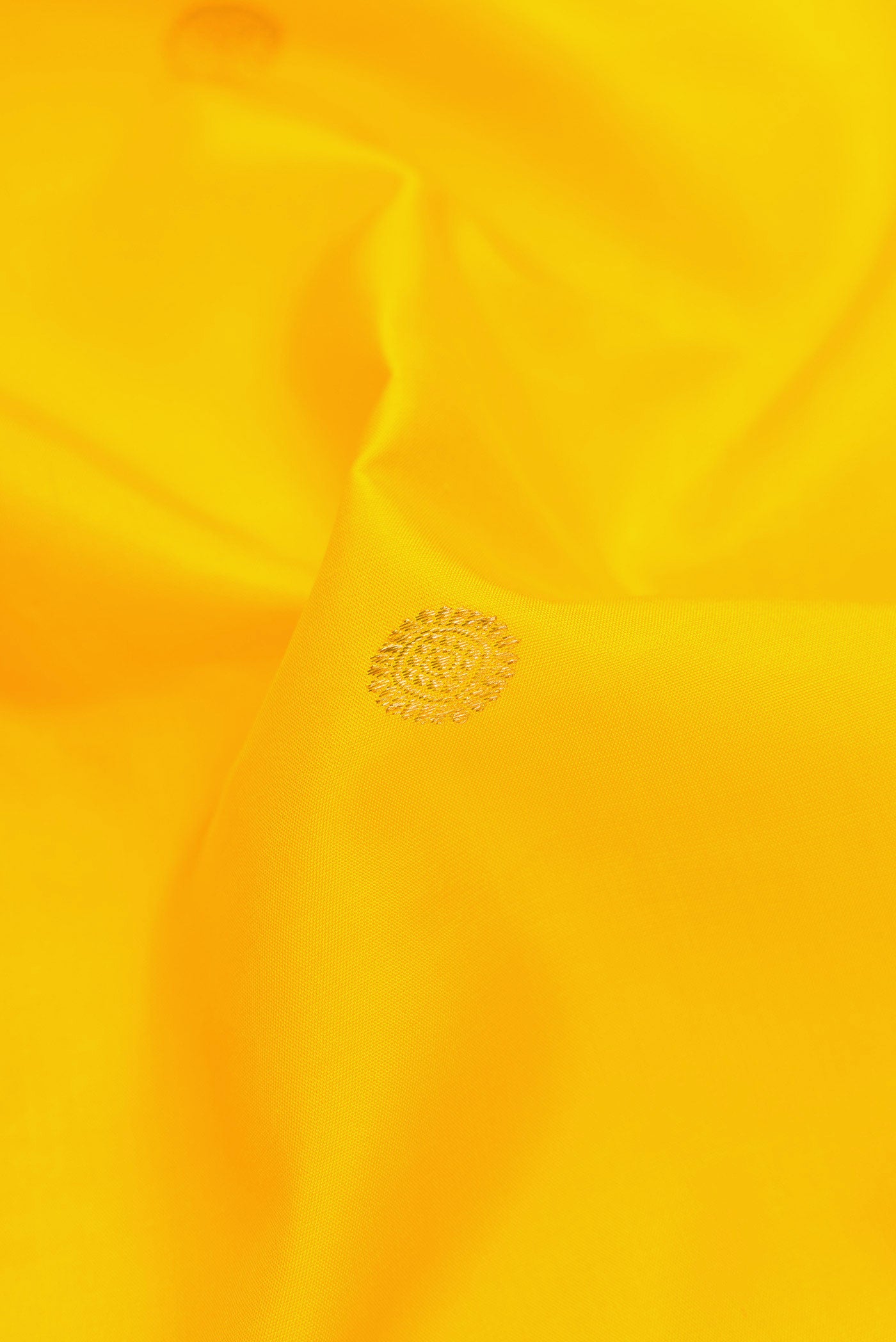 Close up of Yellow Dual Tone Kanjivaram Silk Saree with Zari Butta on the body and Zari Border.  displaying folds