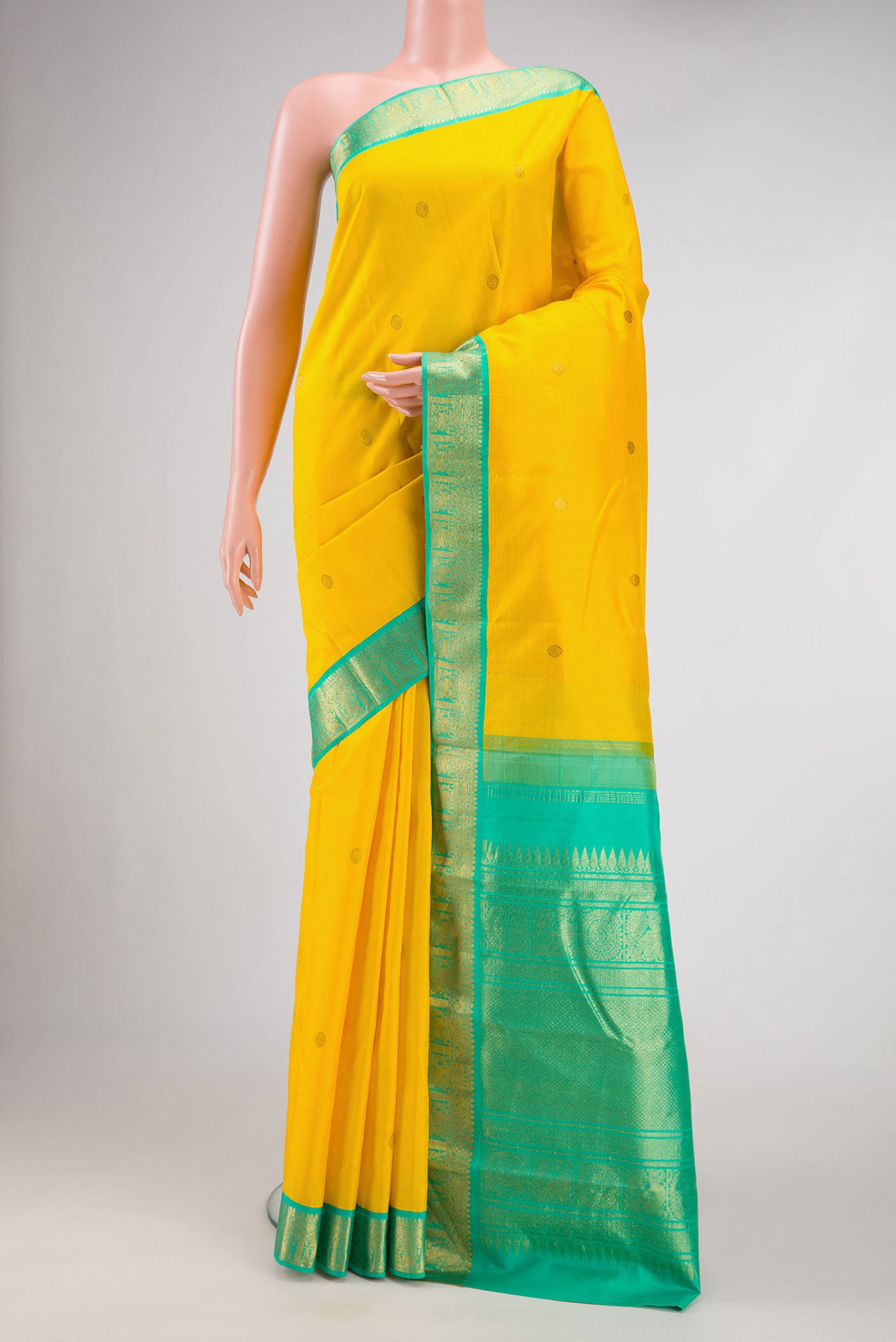 Yellow Dual Tone Kanjivaram Silk Saree with Zari Butta on the body and Zari Border.  displayed on a mannequin