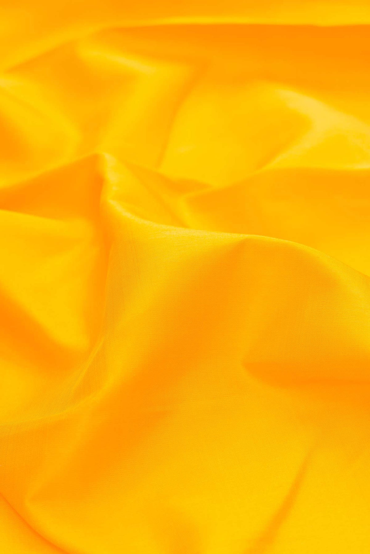 Close up of Yellow Dual Tone Kanchipuram Silk Saree with Plain Body and Temple Border displaying folds