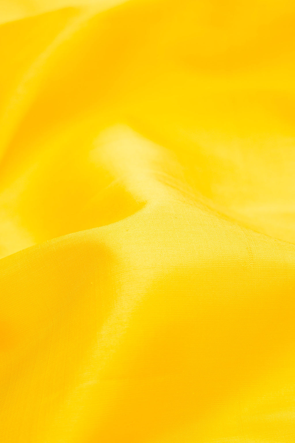 Close up of Pure Silk Pure Zari Yellow Dual Tone Kanjivaram Saree with Plain Body and Zari Border.  displaying folds