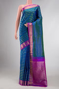 Peacock Blue Dual Tone Kanchipuram Silk Saree with Stripes on the body and Zari Border displayed on a mannequin