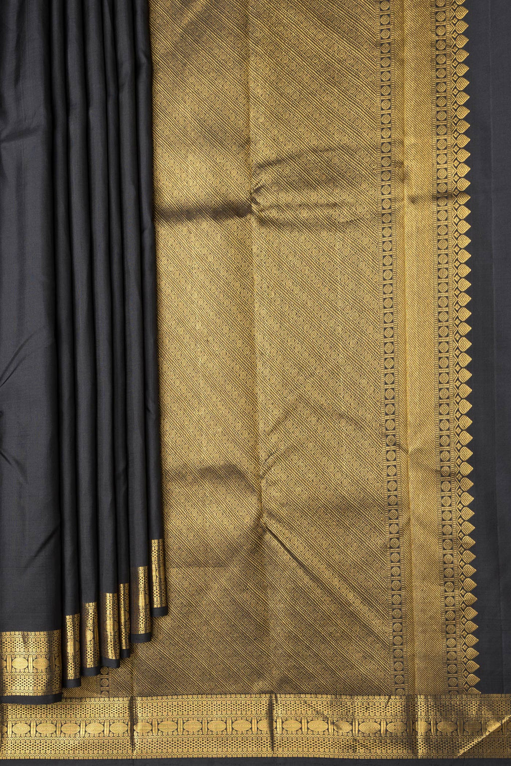 Pleats and pallu of Black Dual Tone Kanchipuram Silk Saree with Zari Butta on the body and Zari Border. 