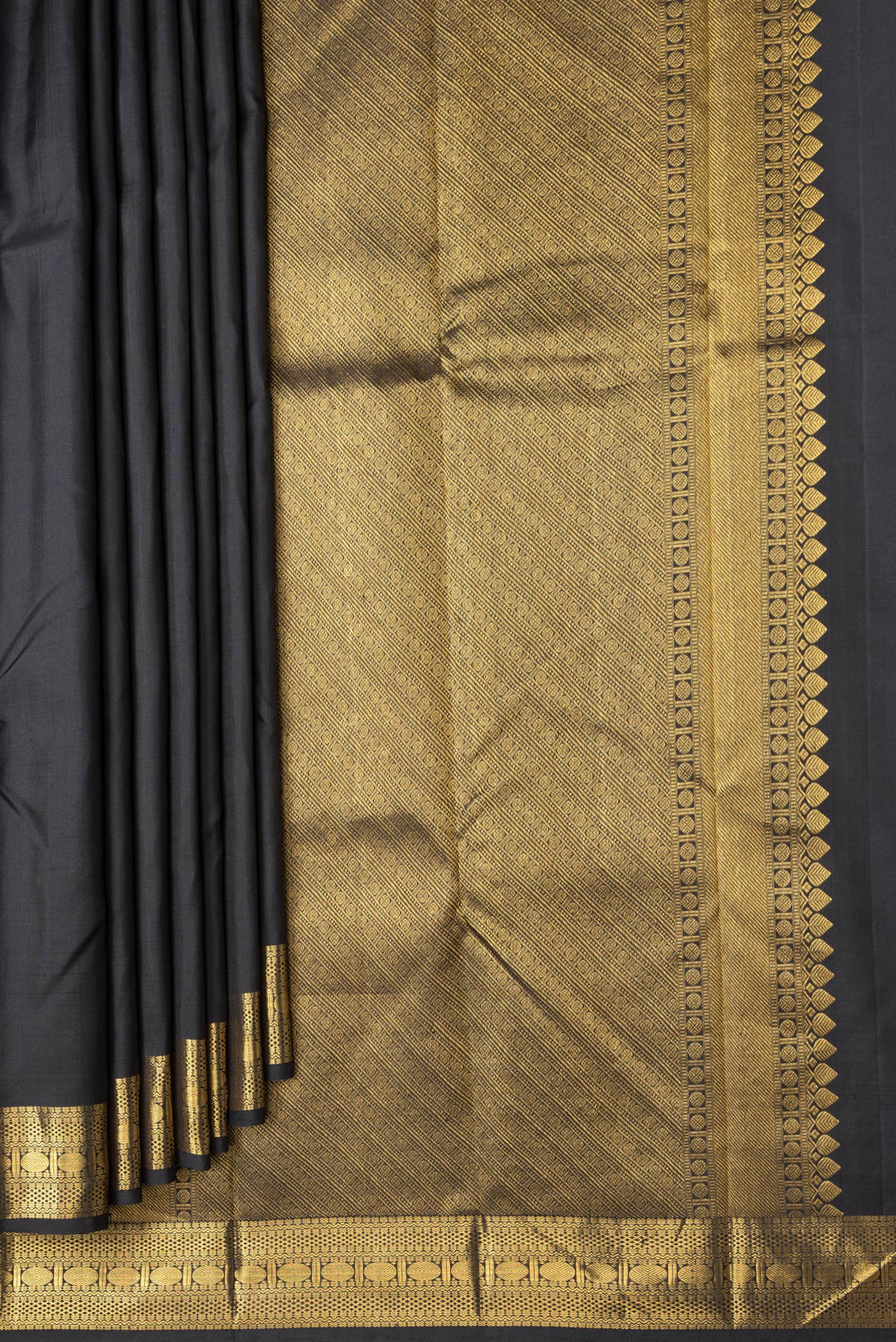 Pleats and pallu of Black Dual Tone Kanchipuram Silk Saree with Zari Butta on the body and Zari Border. 