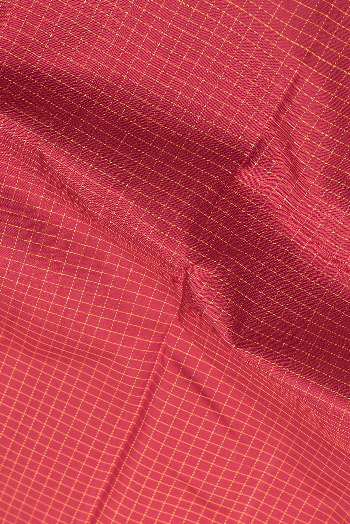 Close up of Maroon Dual Tone Kanchipuram Silk Saree with Checked design on the body and Zari Border.  displaying folds