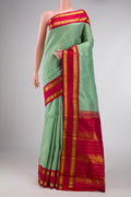 Green Dual Tone Kanchipuram Silk Saree with Checked design on the body and Zari Border displayed on a mannequin