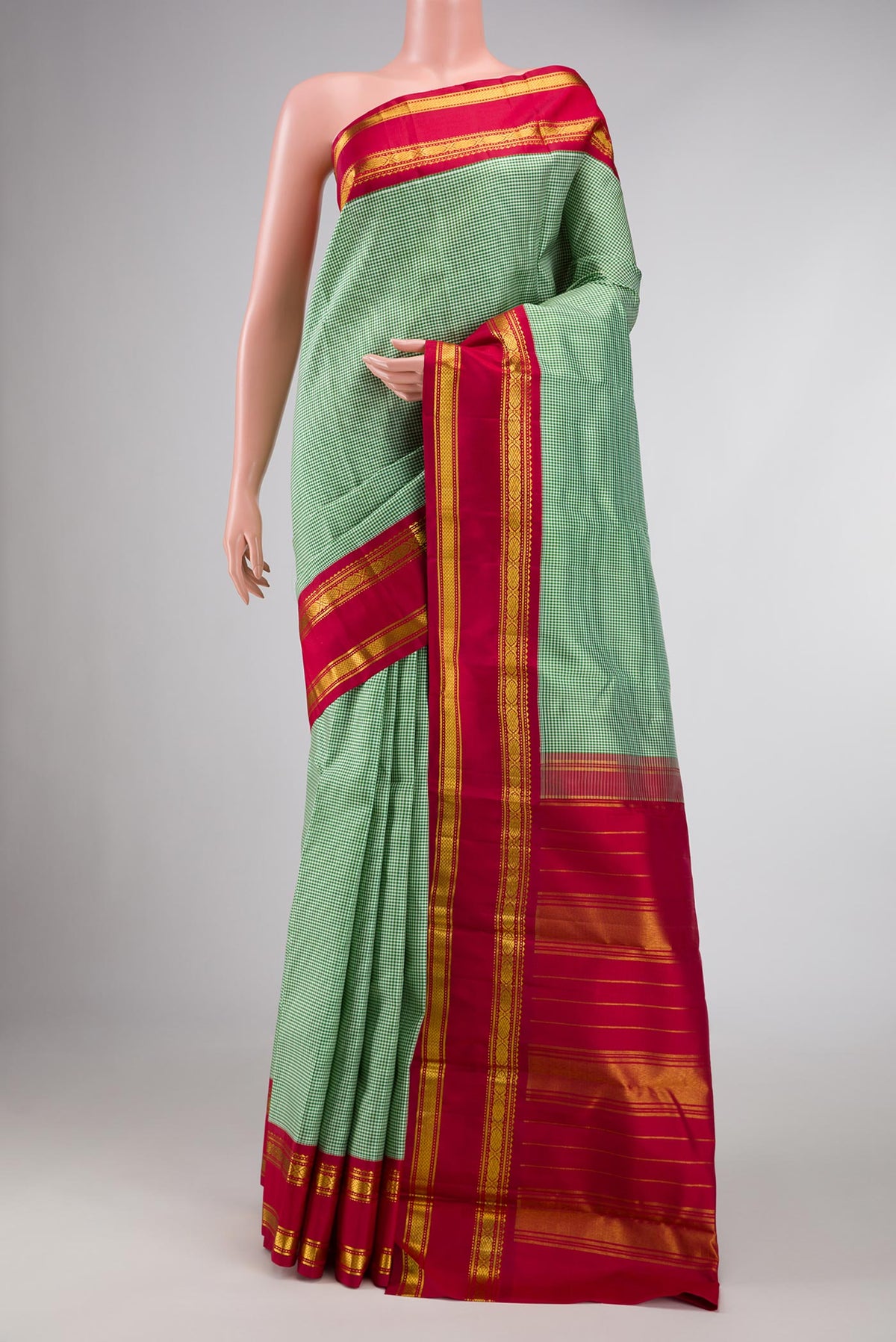 Green Dual Tone Kanchipuram Silk Saree with Checked design on the body and Zari Border displayed on a mannequin