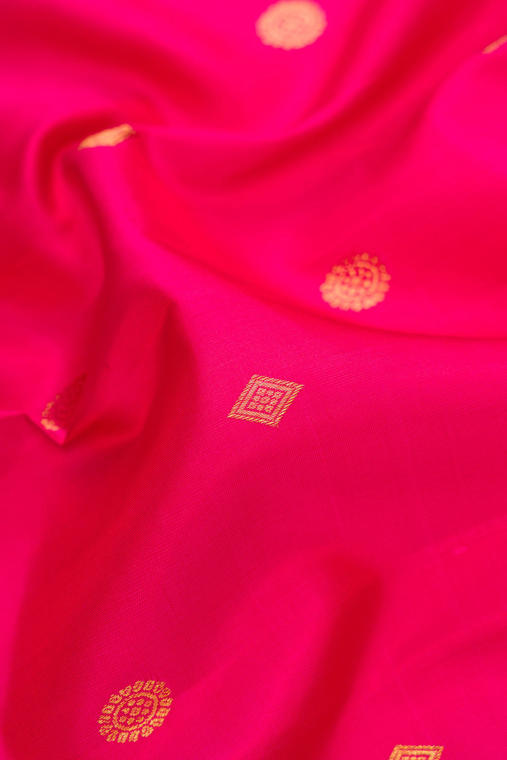 Close up of Pink Dual Tone Kanjivaram Silk Saree with Zari Butta on the body and Zari Border.  displaying folds