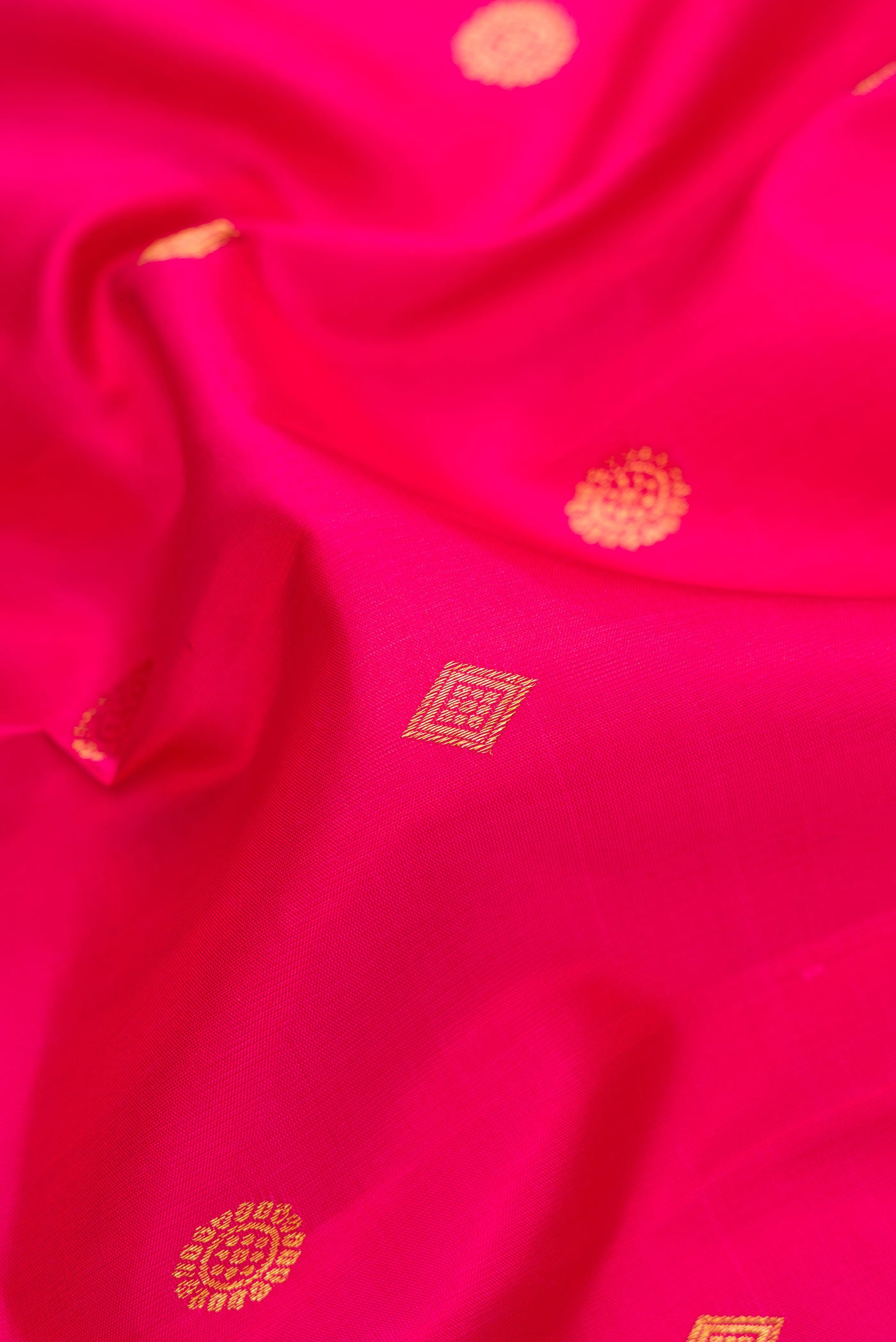 Close up of Pink Dual Tone Kanjivaram Silk Saree with Zari Butta on the body and Zari Border.  displaying folds